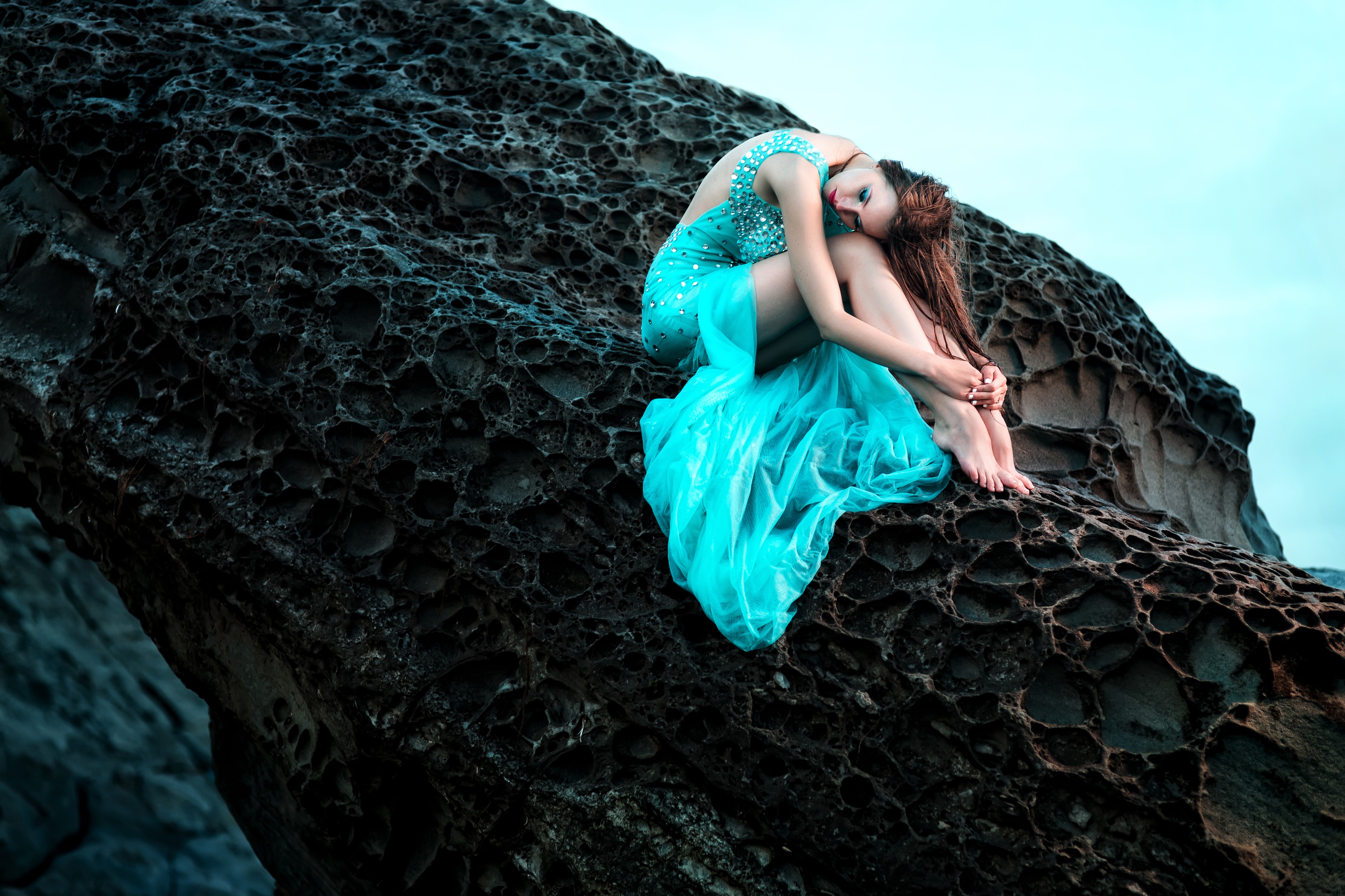Woman in blue dress sitting on a rock HD Wallpaper