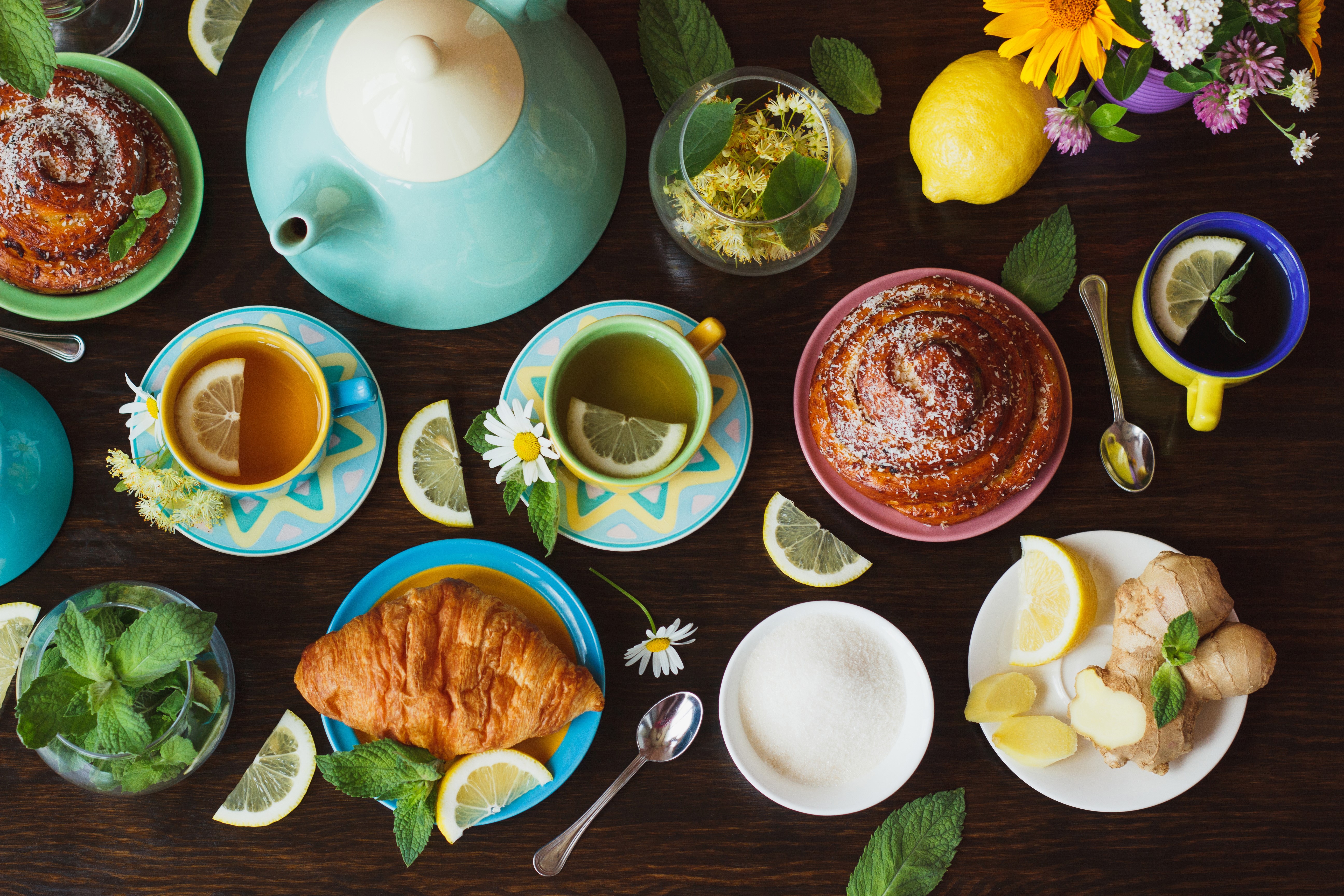 Tea set with buns, croissants, lemons, and ginger HD Wallpaper