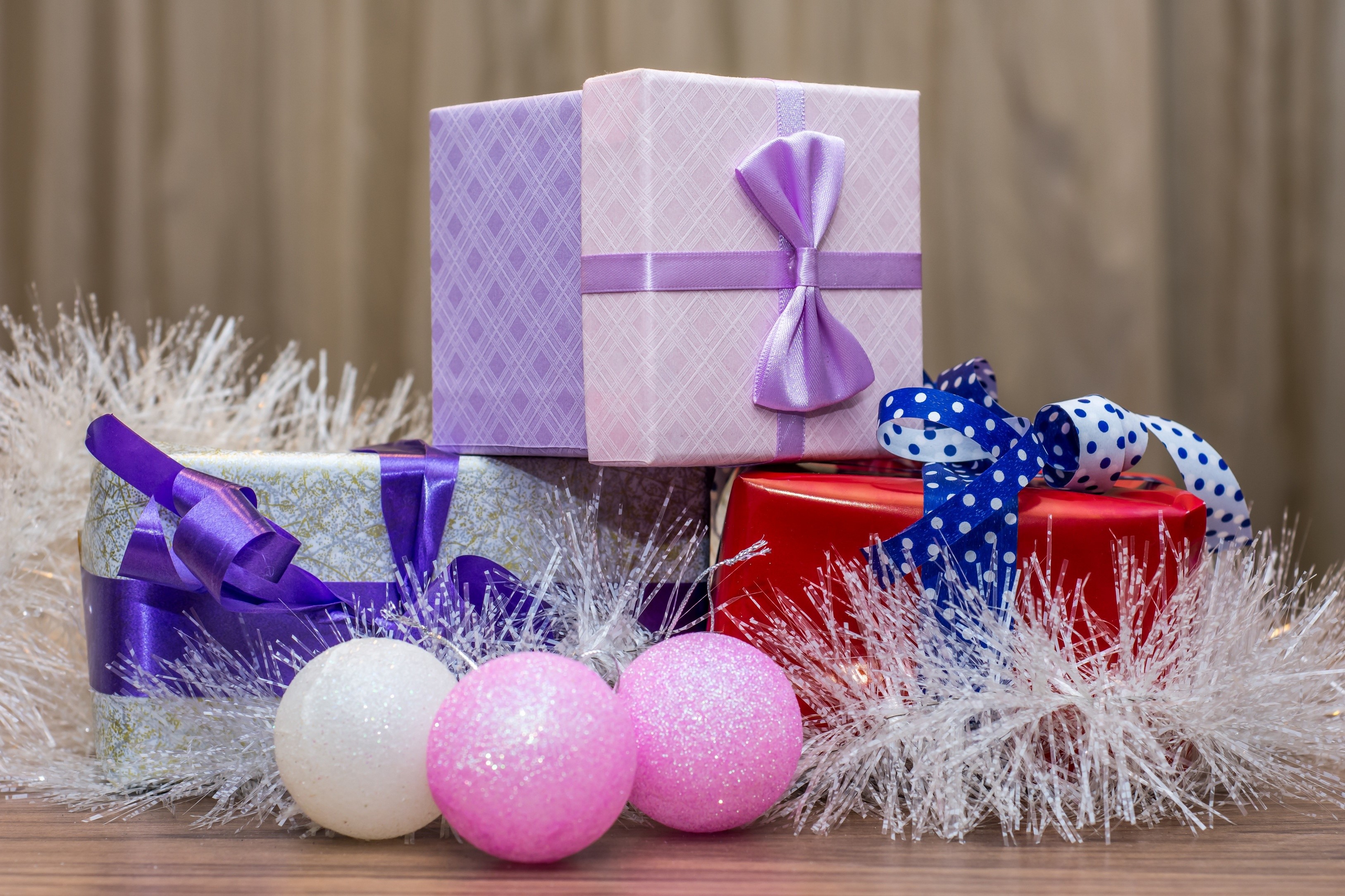 Christmas gifts and ornaments on a wooden surface HD Wallpaper