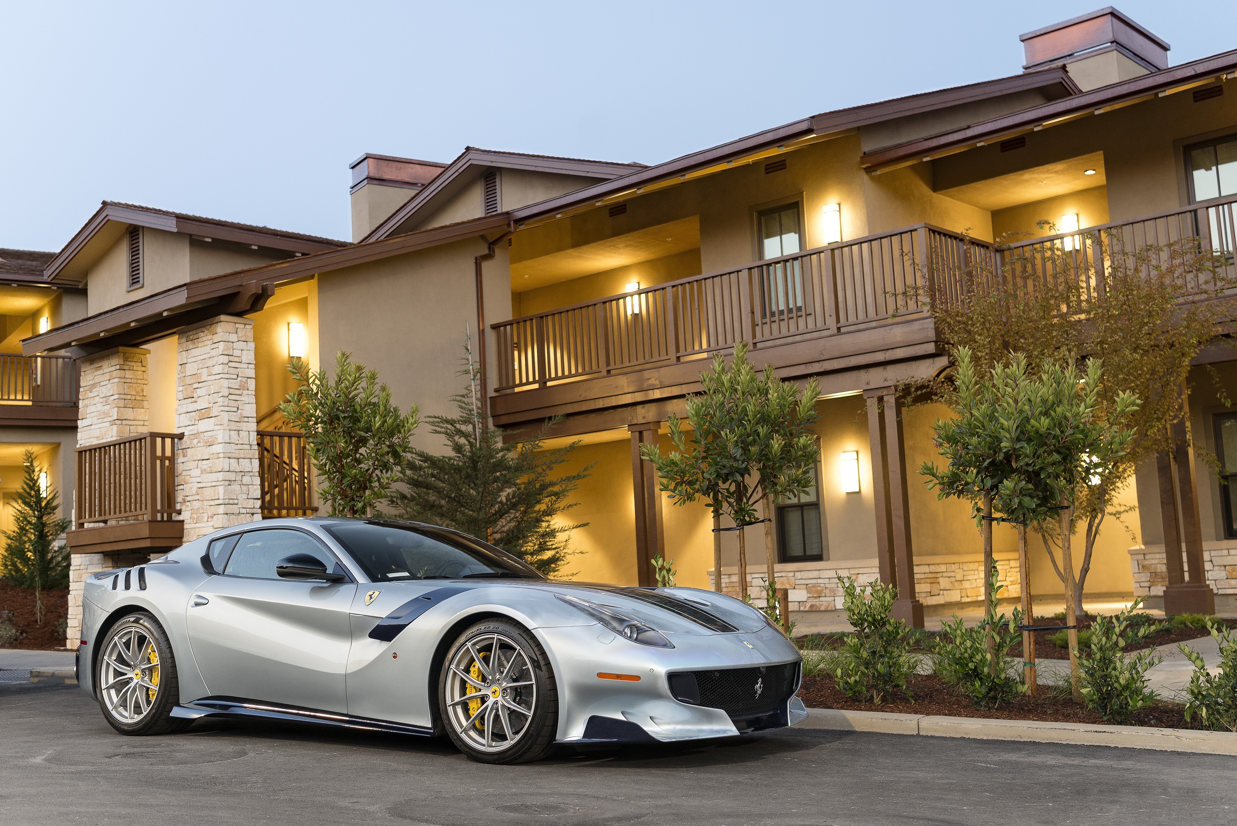 Silver Ferrari F12tdf parked in front of a building HD Wallpaper