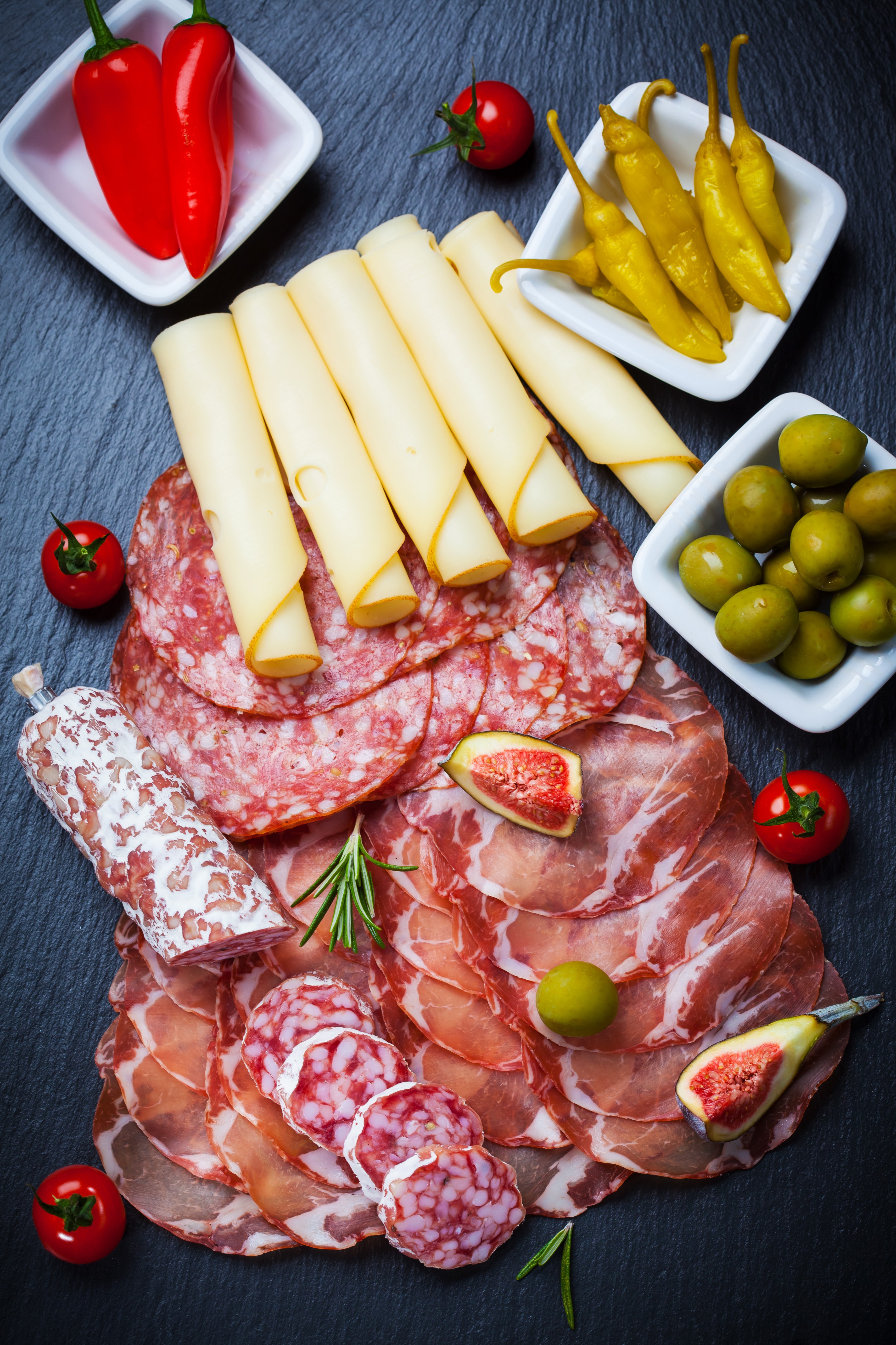 Charcuterie board with cured meats, cheese, olives, and peppers HD Phone Wallpaper