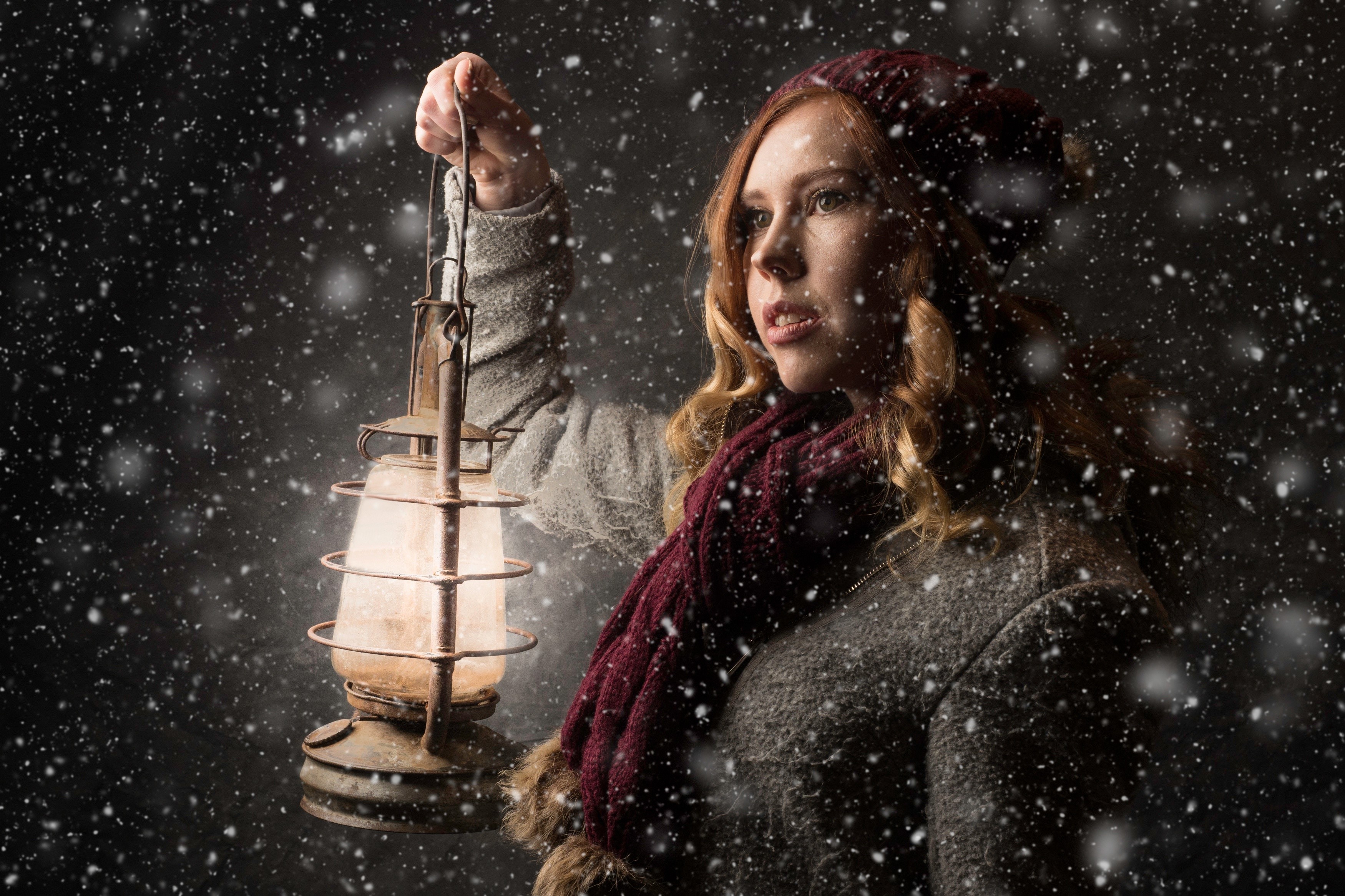 Woman holding a lantern in the snow HD Wallpaper