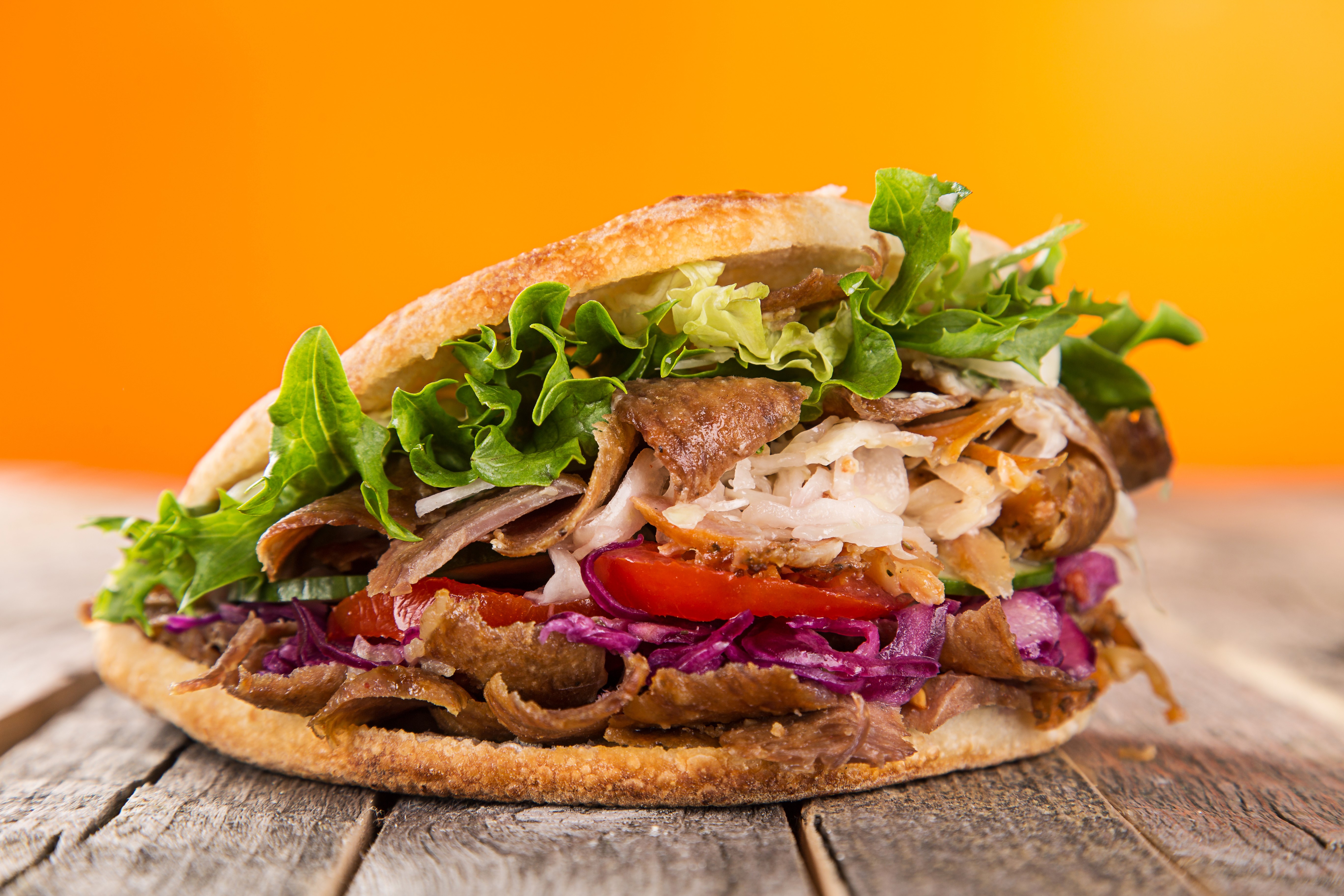 Doner Kebab Sandwich with Vegetables on Wood Planks HD Wallpaper