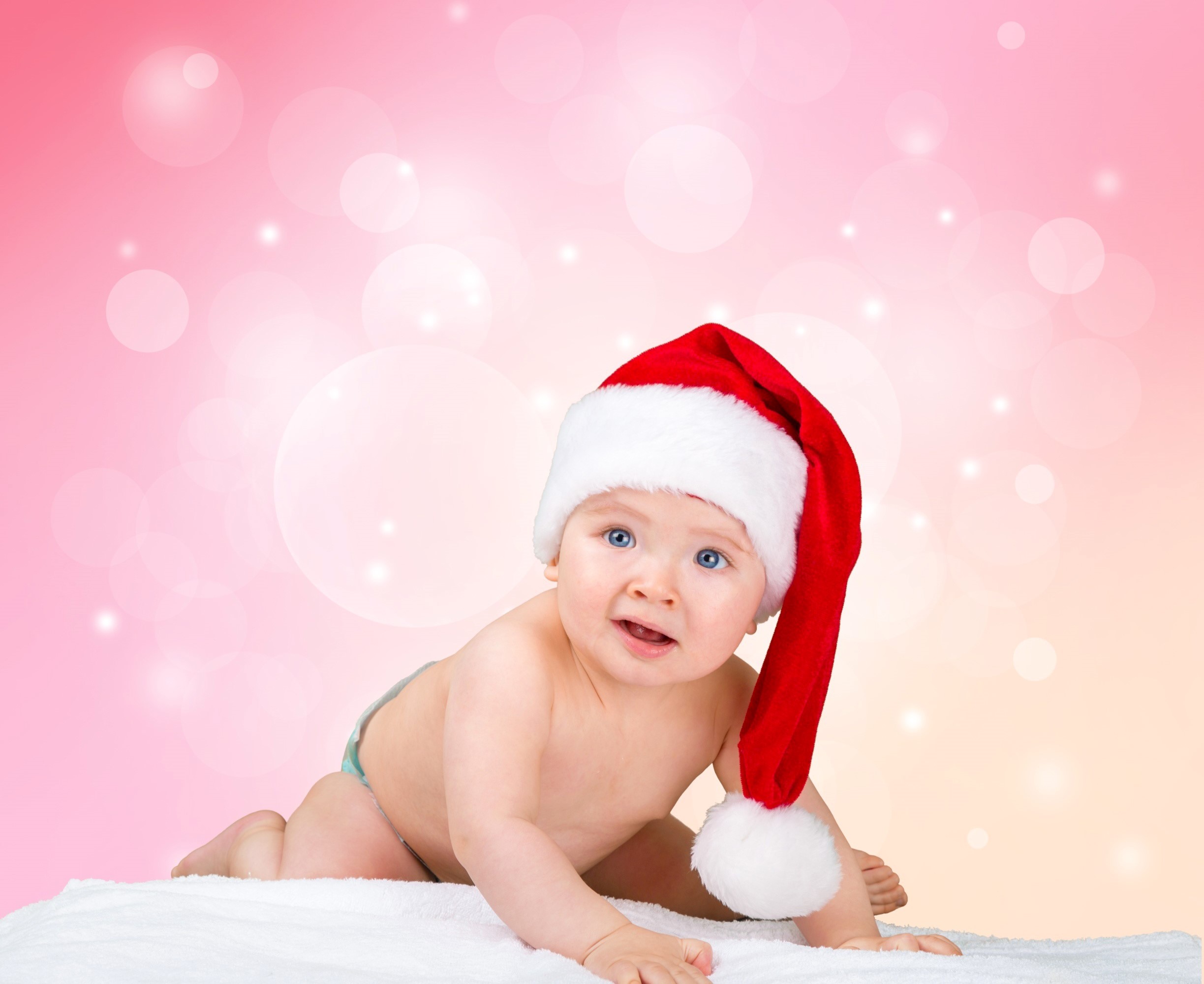 Baby in Santa hat crawling on white blanket HD Wallpaper