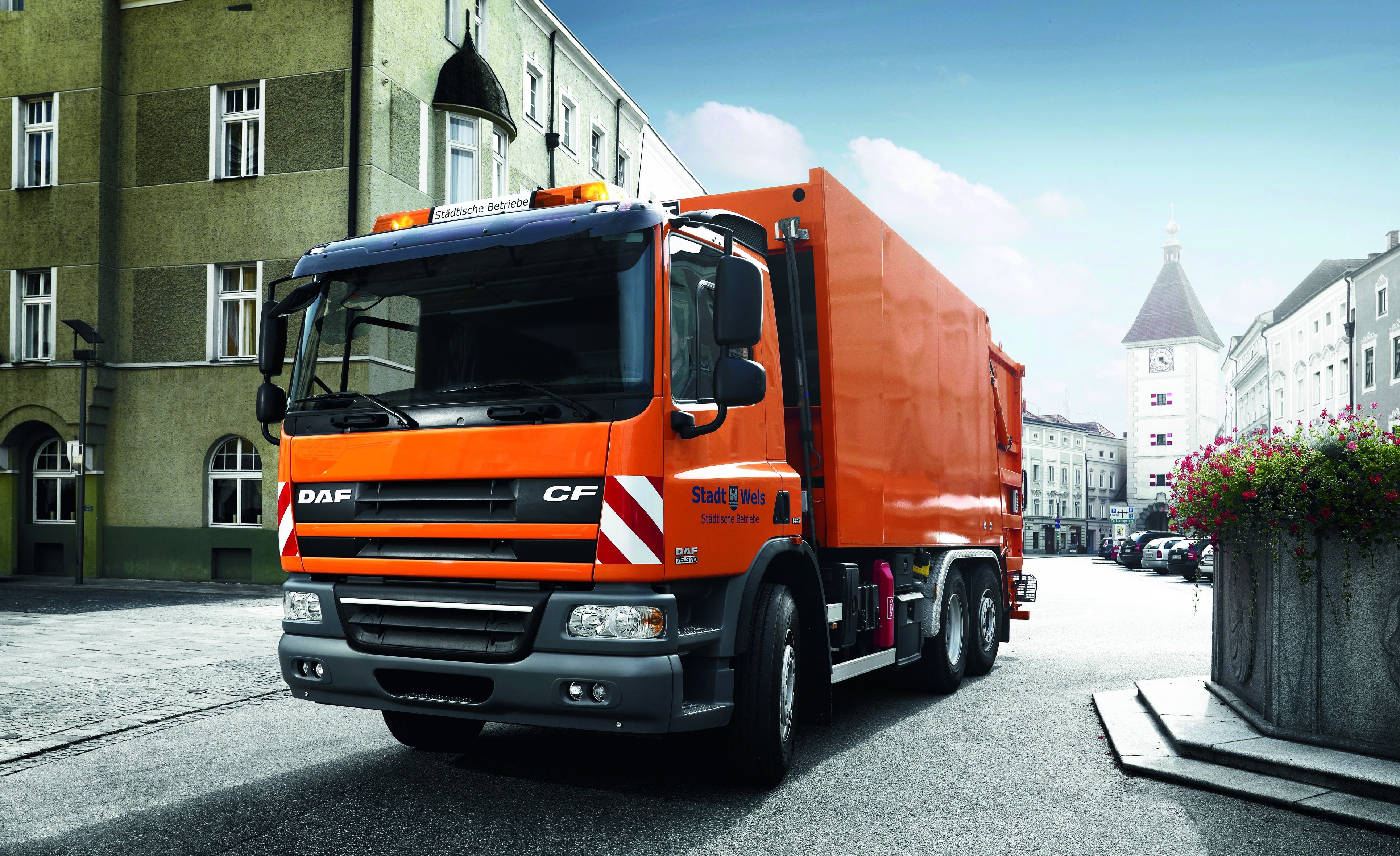 Orange DAF CF garbage truck in Wels HD Wallpaper