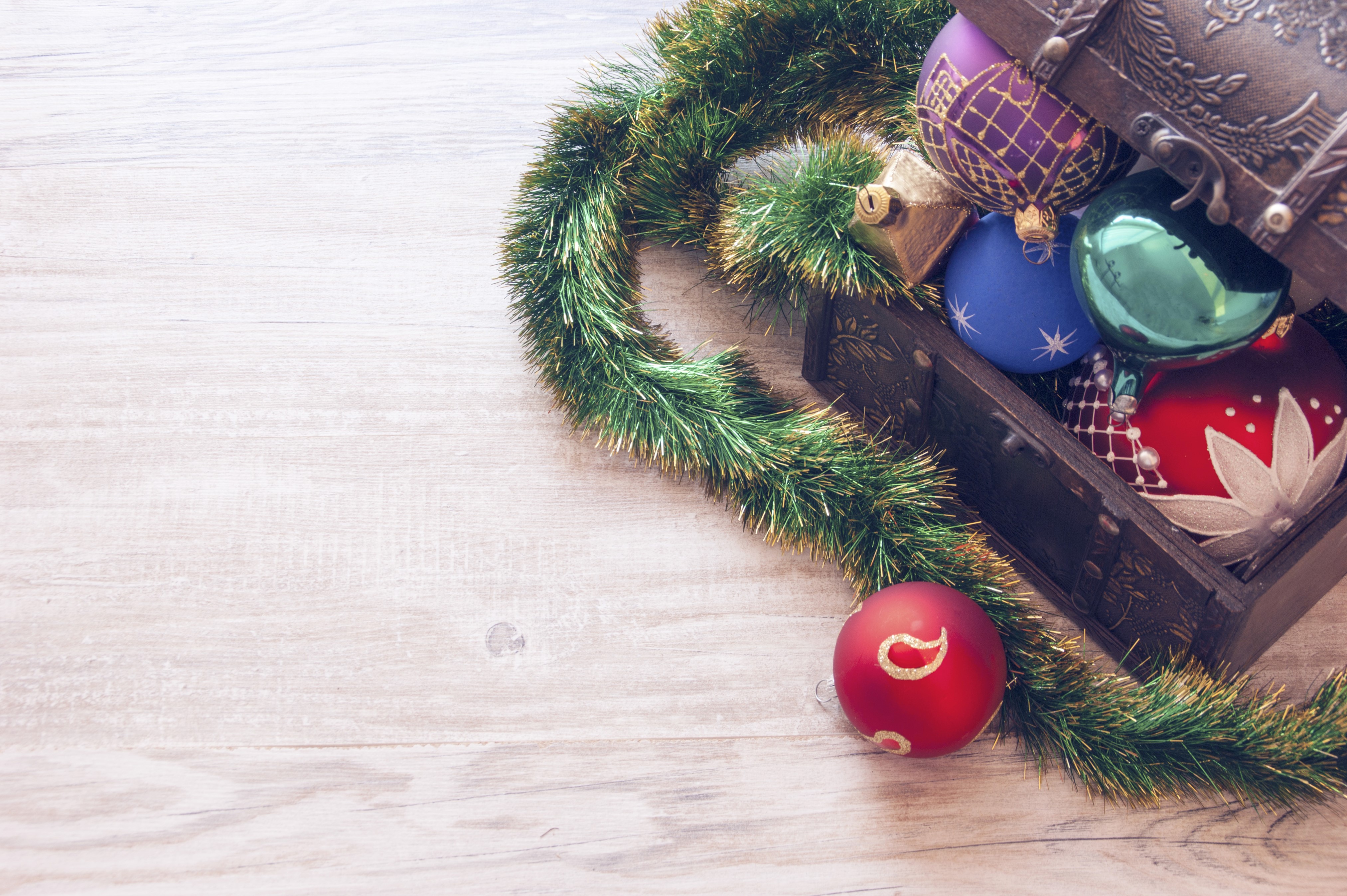 Christmas ornaments in a treasure chest with garland HD Wallpaper