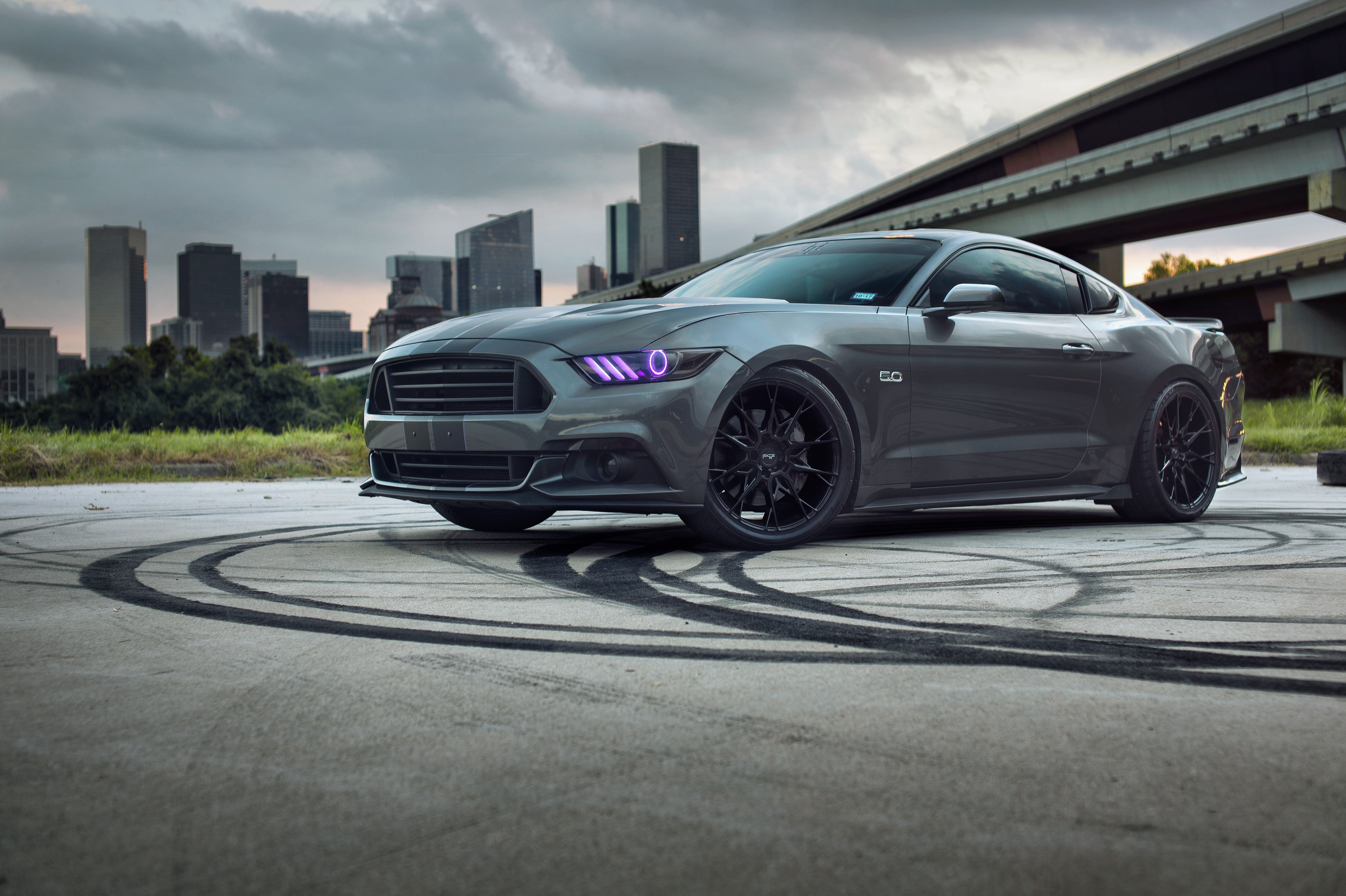 Grey Ford Mustang with purple headlights and tire marks HD Wallpaper