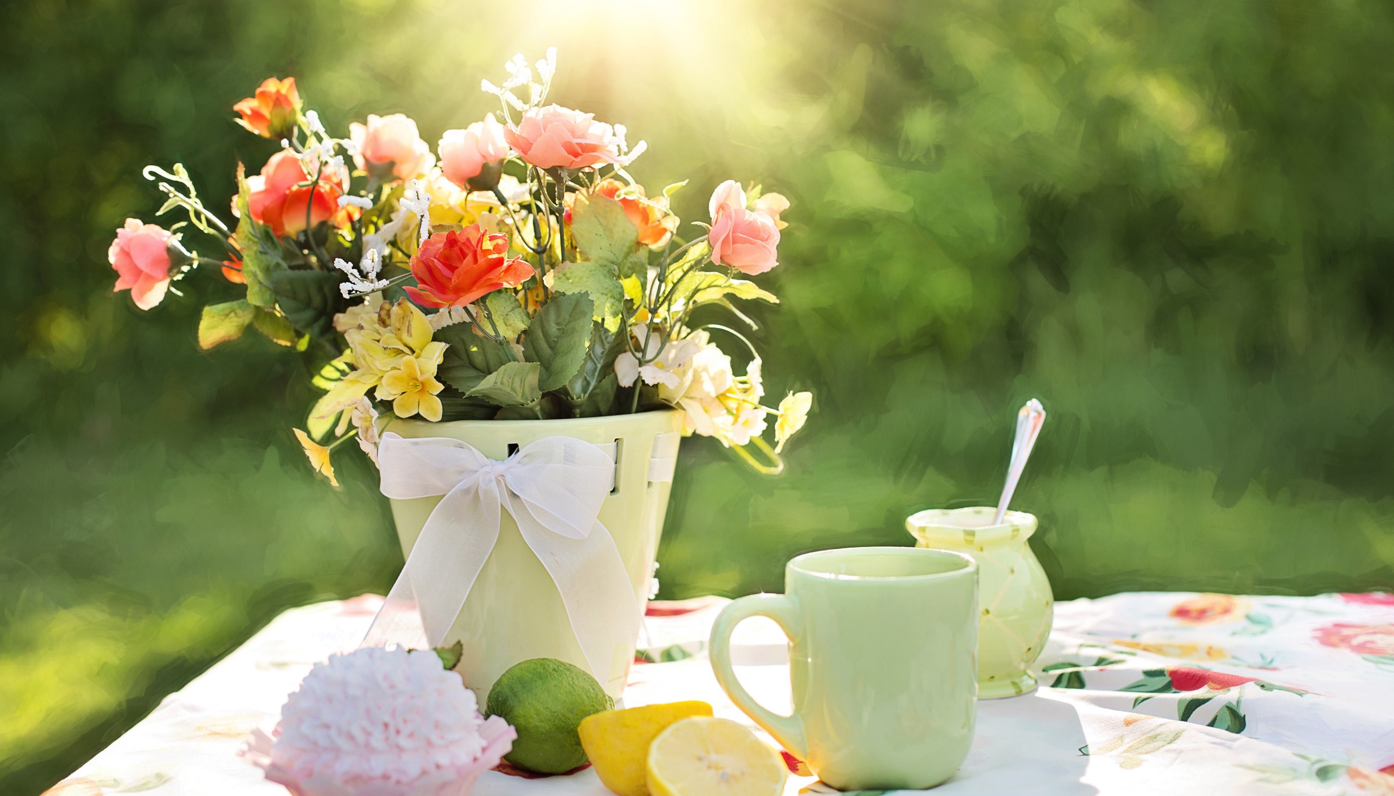 Bouquet of flowers with a cup and fruit on a table HD Wallpaper
