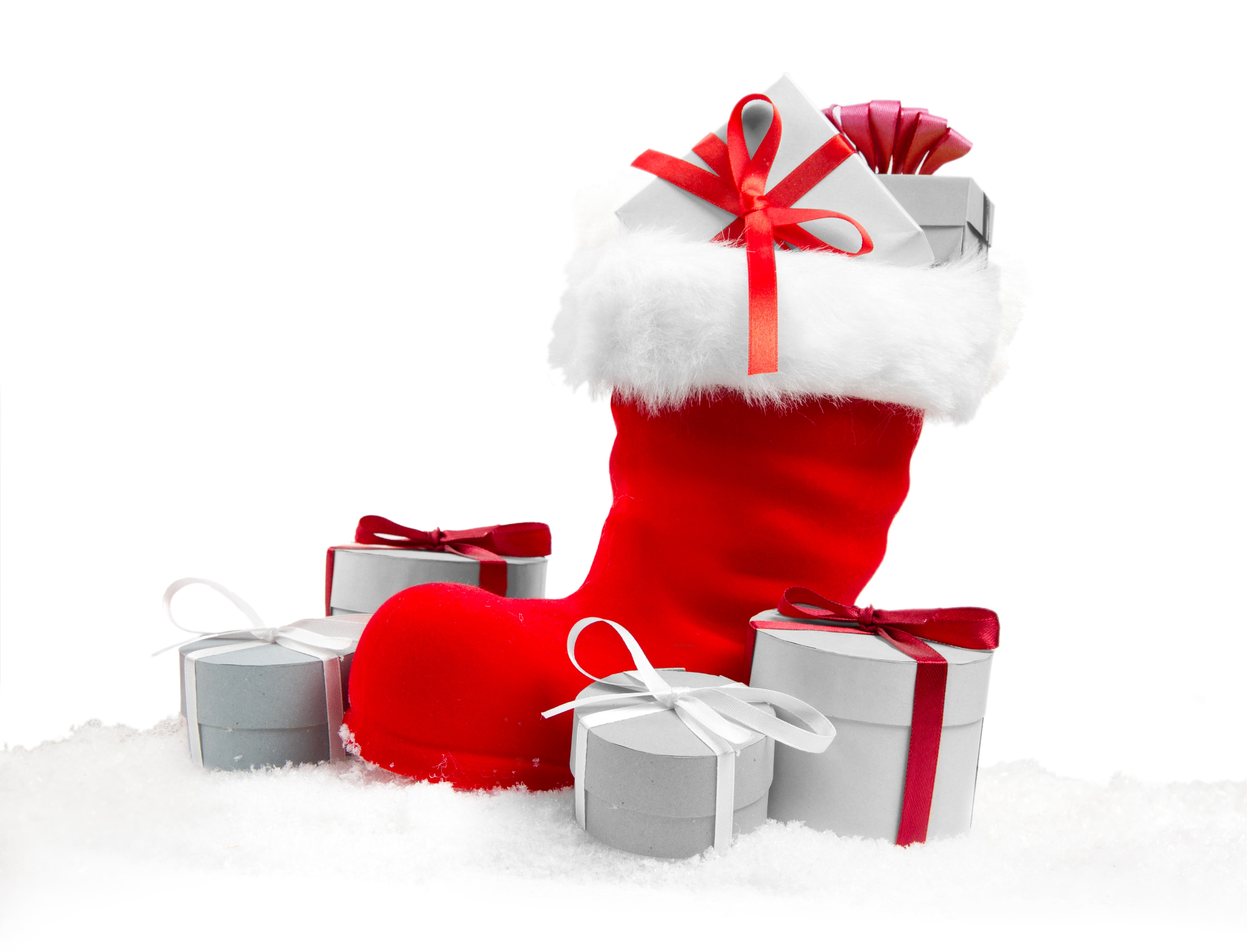 Christmas stocking filled with gifts on snow HD Wallpaper