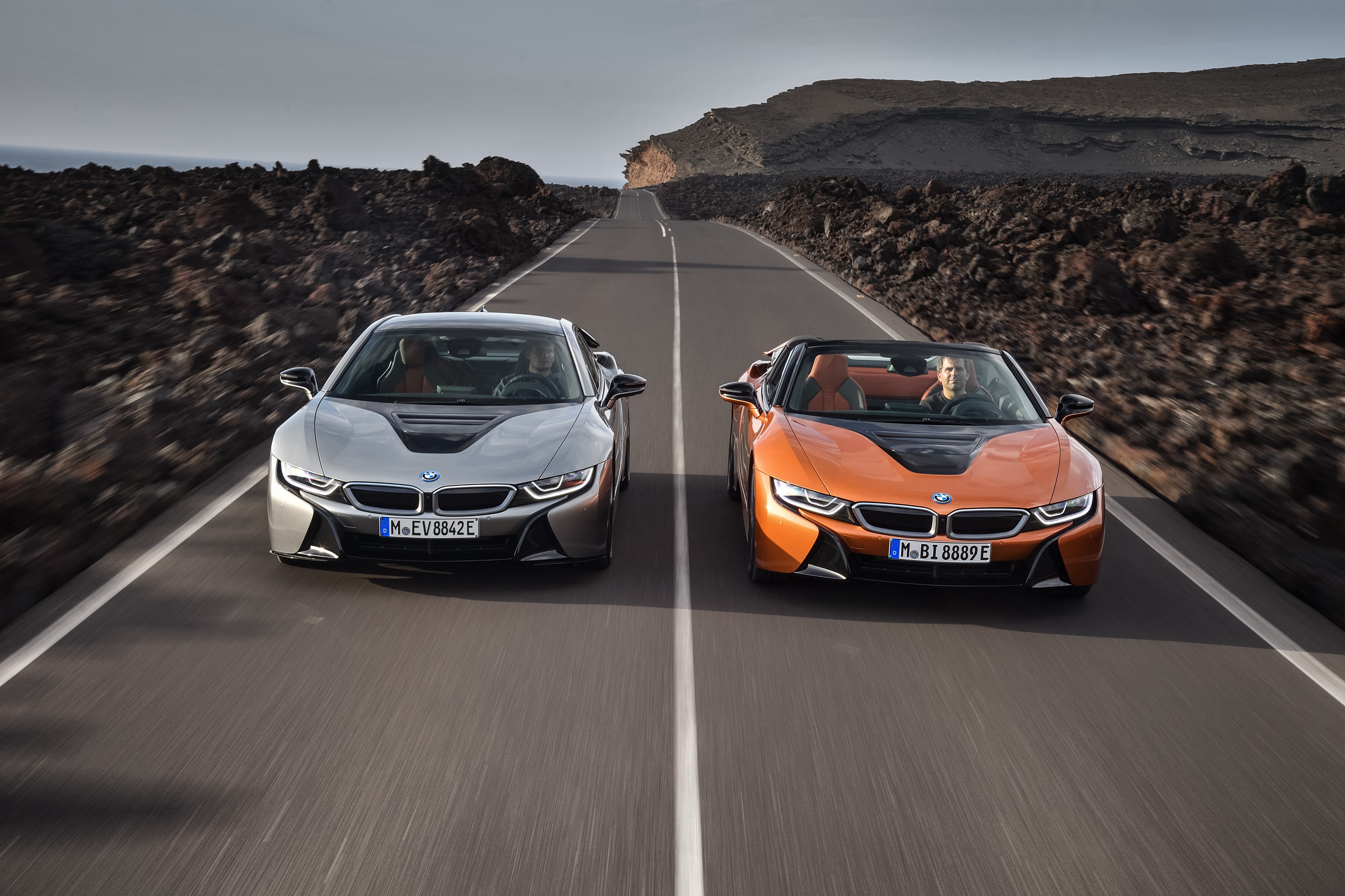 Two BMW i8 cars on a road HD Wallpaper