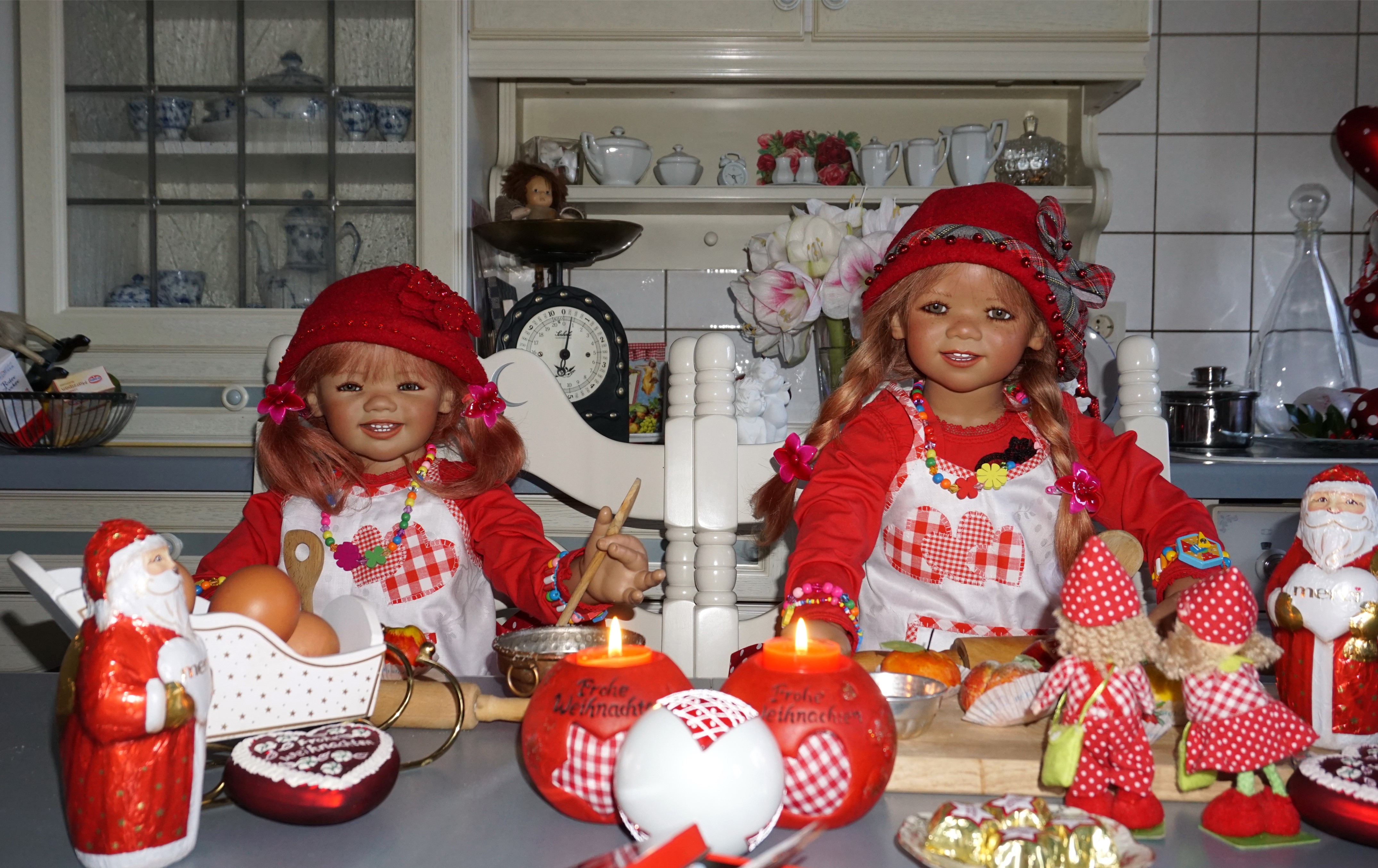 Two dolls in Christmas attire with Santa Claus figures HD Wallpaper
