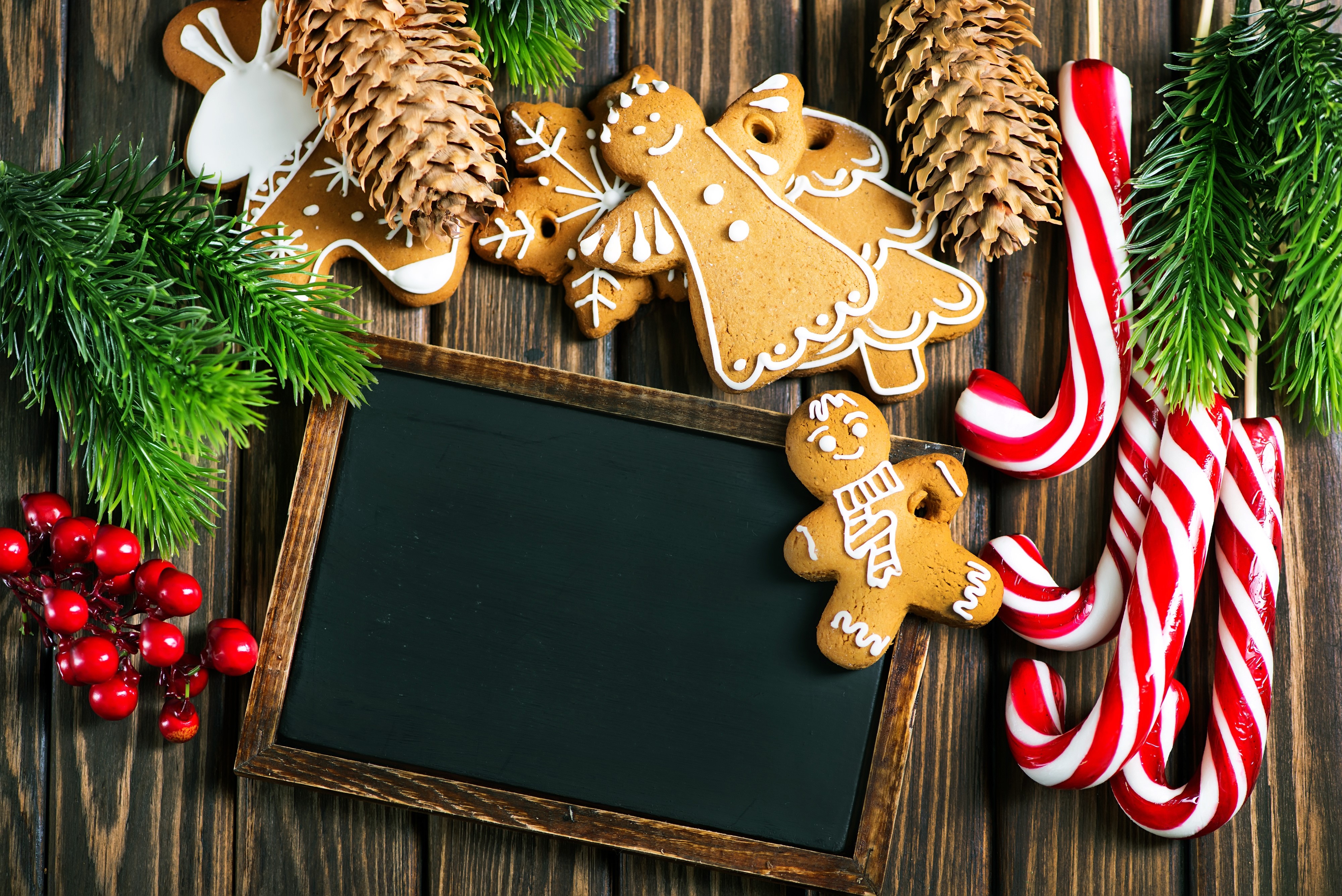 Christmas gingerbread cookies and candy canes on wood HD Wallpaper