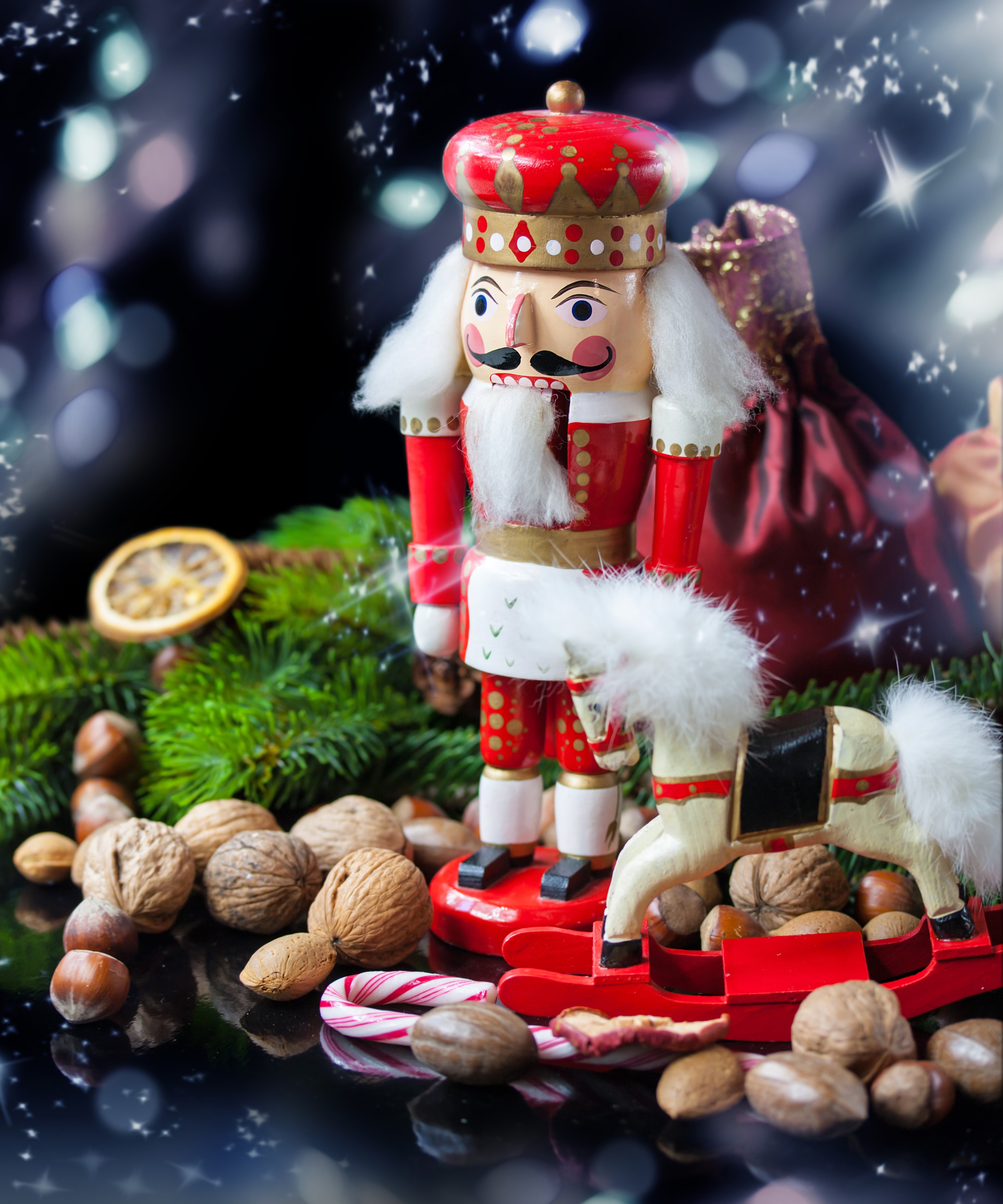 Christmas nutcracker with rocking horse and nuts HD Wallpaper
