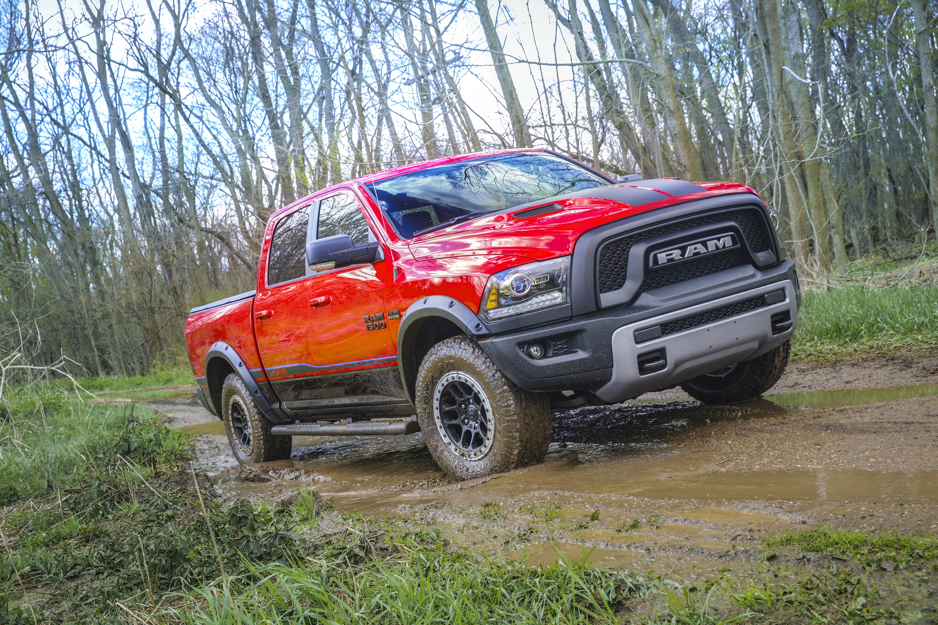 Red Ram 1500 Rebel Crew Cab driving through mud HD Wallpaper