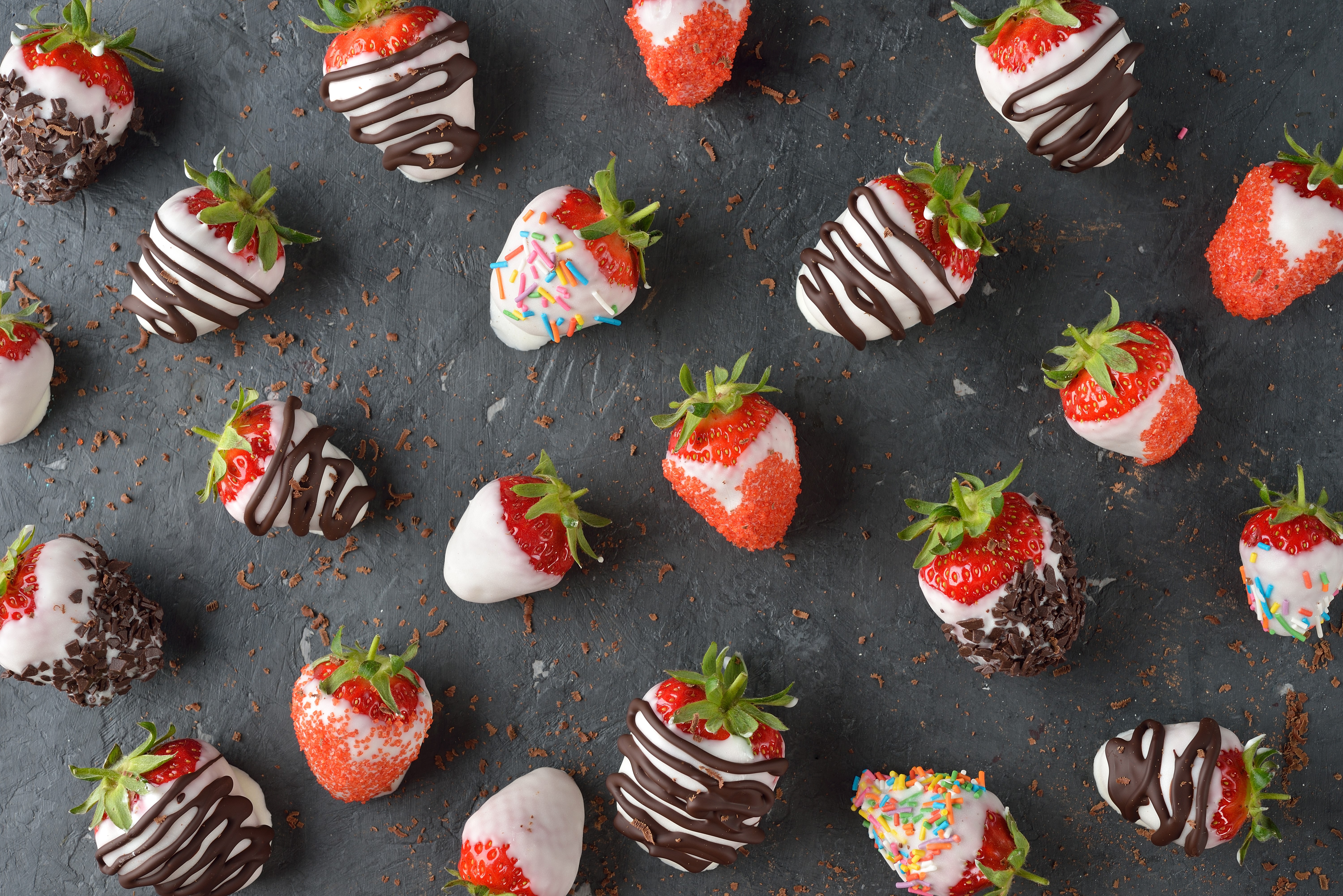 Chocolate-dipped strawberries with toppings on gray background HD Wallpaper