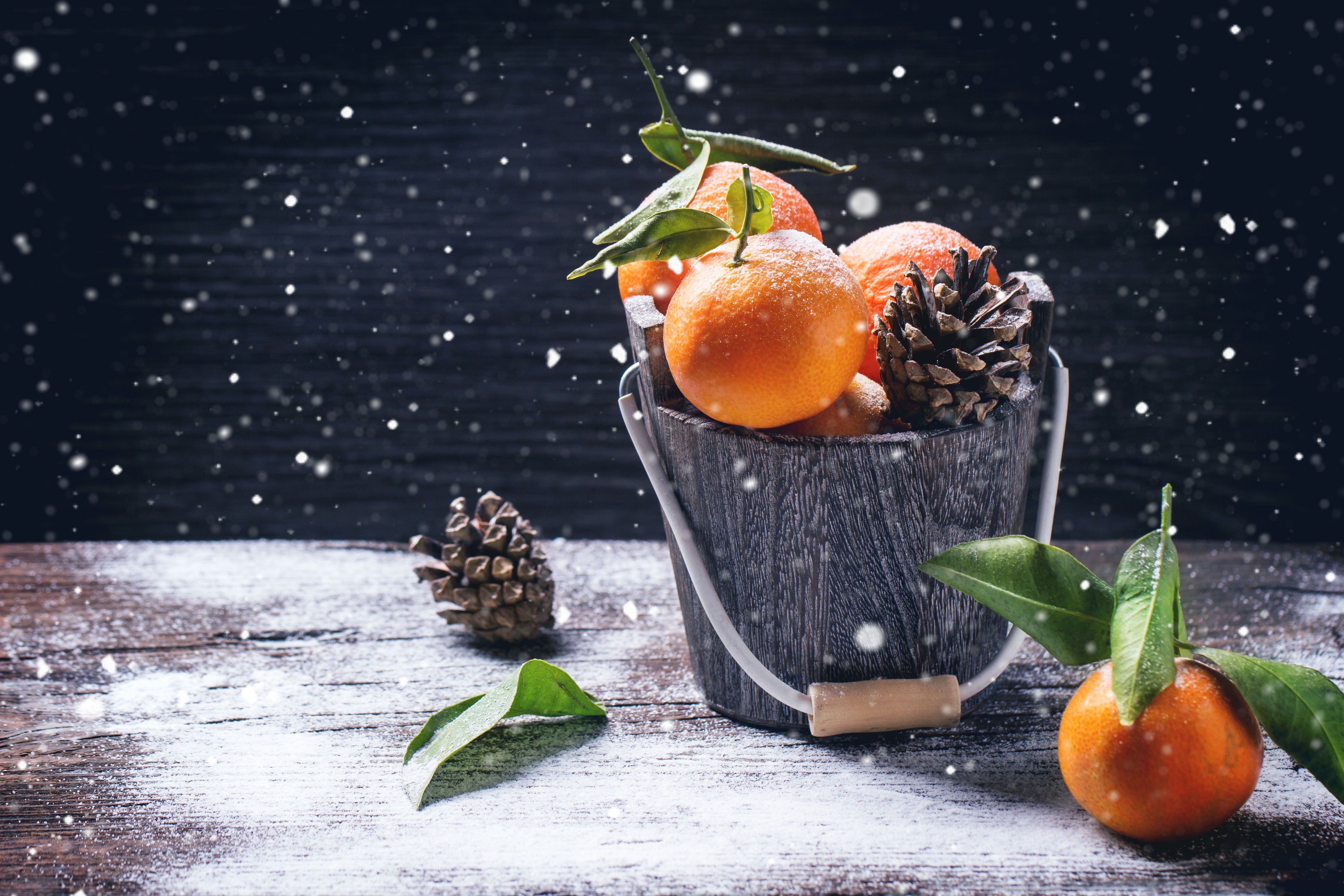 Bucket of Mandarines and Pine Cones with Snow HD Wallpaper