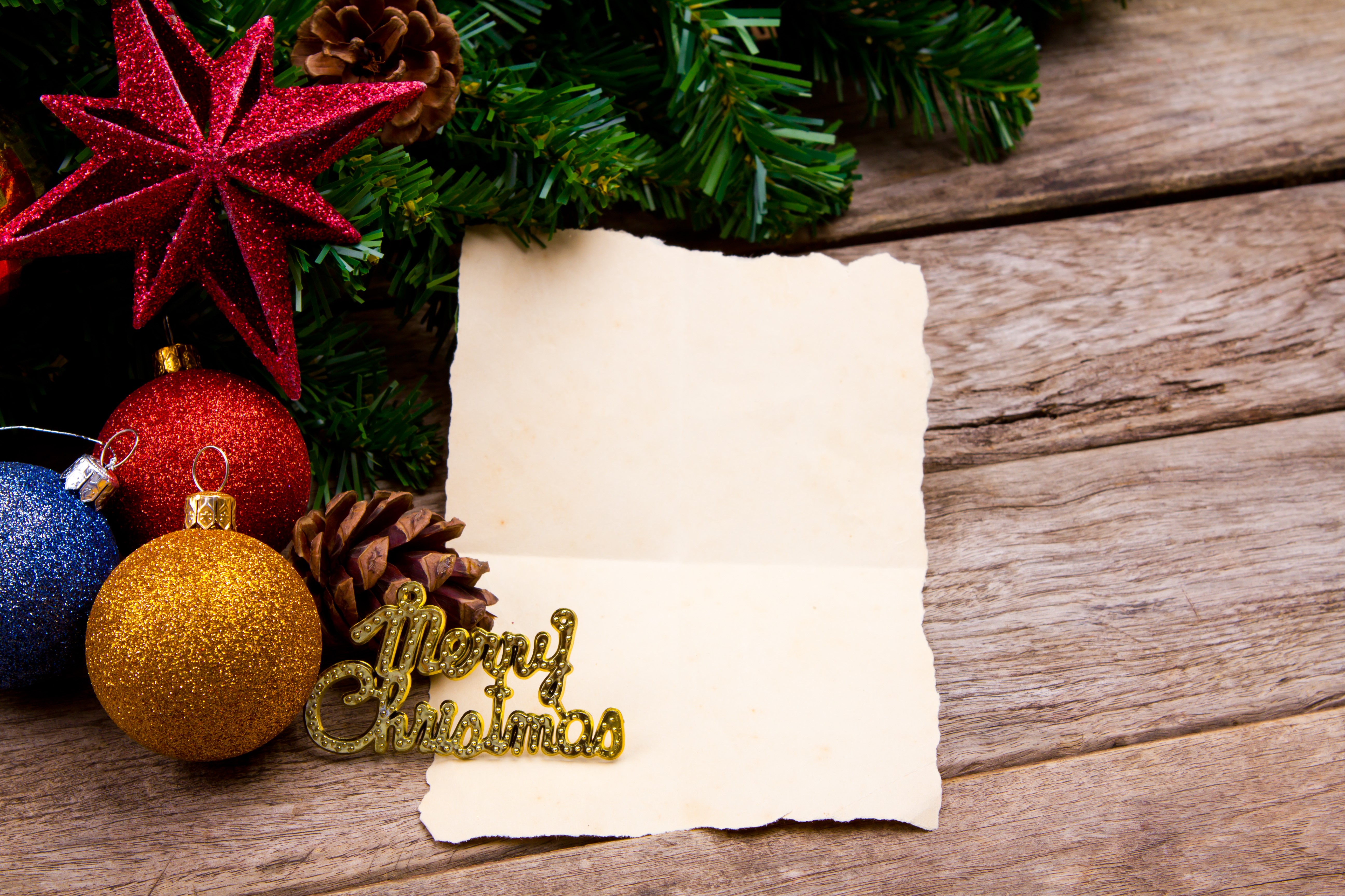 Christmas ornaments and paper on wood planks HD Wallpaper