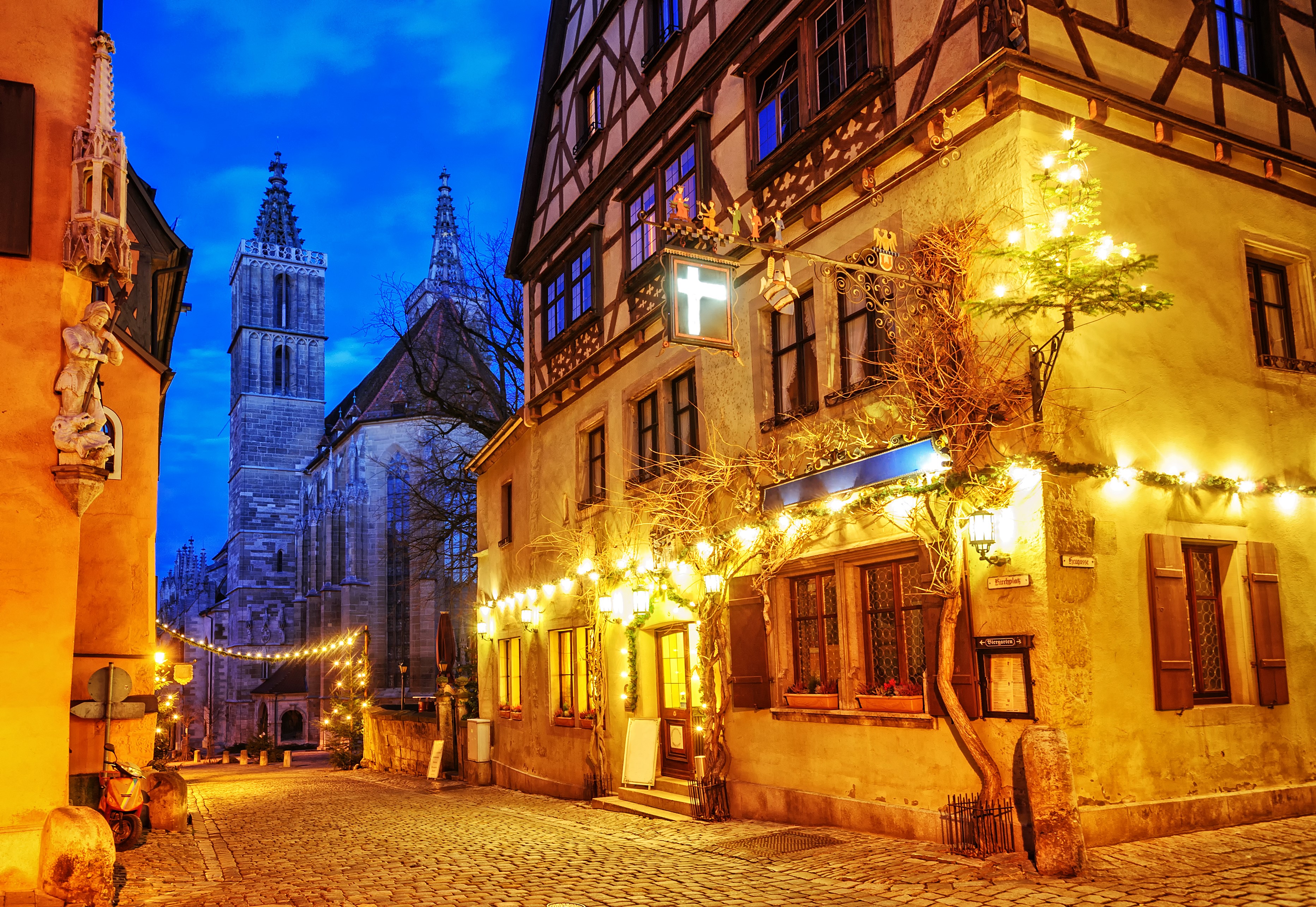 Rothenburg street with church and Christmas lights at dusk HD Wallpaper