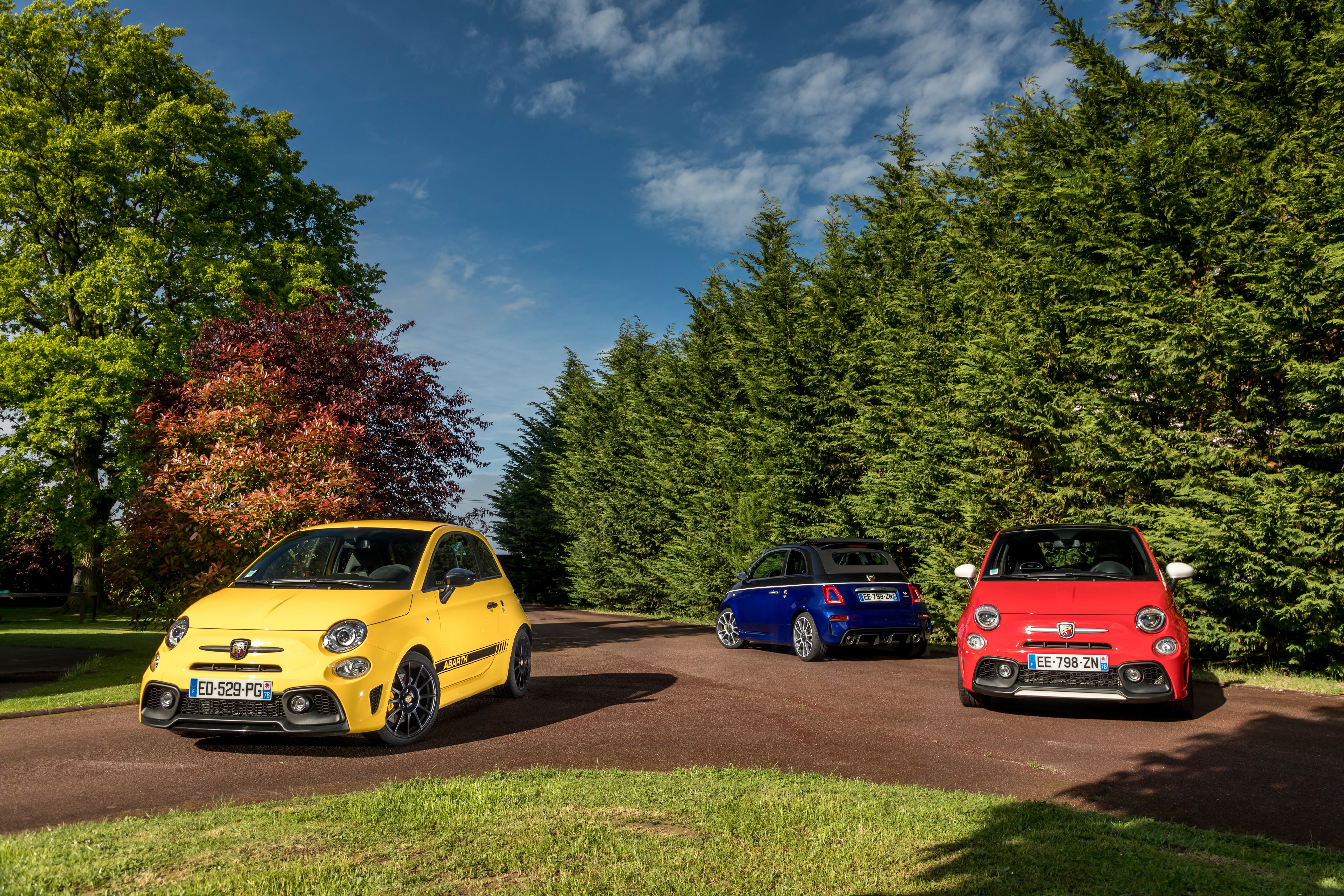 Three Abarth 595 Coupes on a Driveway HD Wallpaper