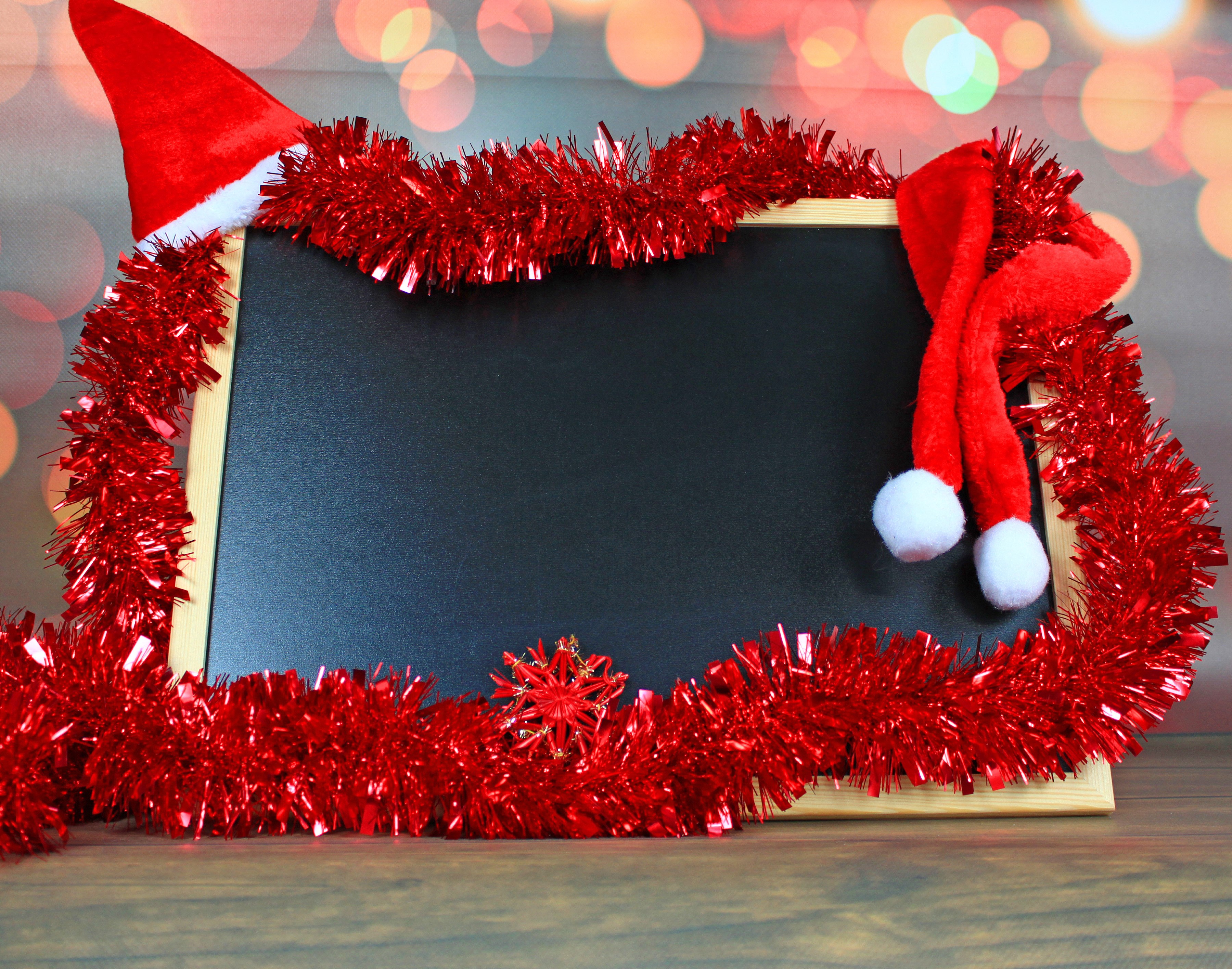 Christmas blackboard with Santa hats and tinsel HD Wallpaper