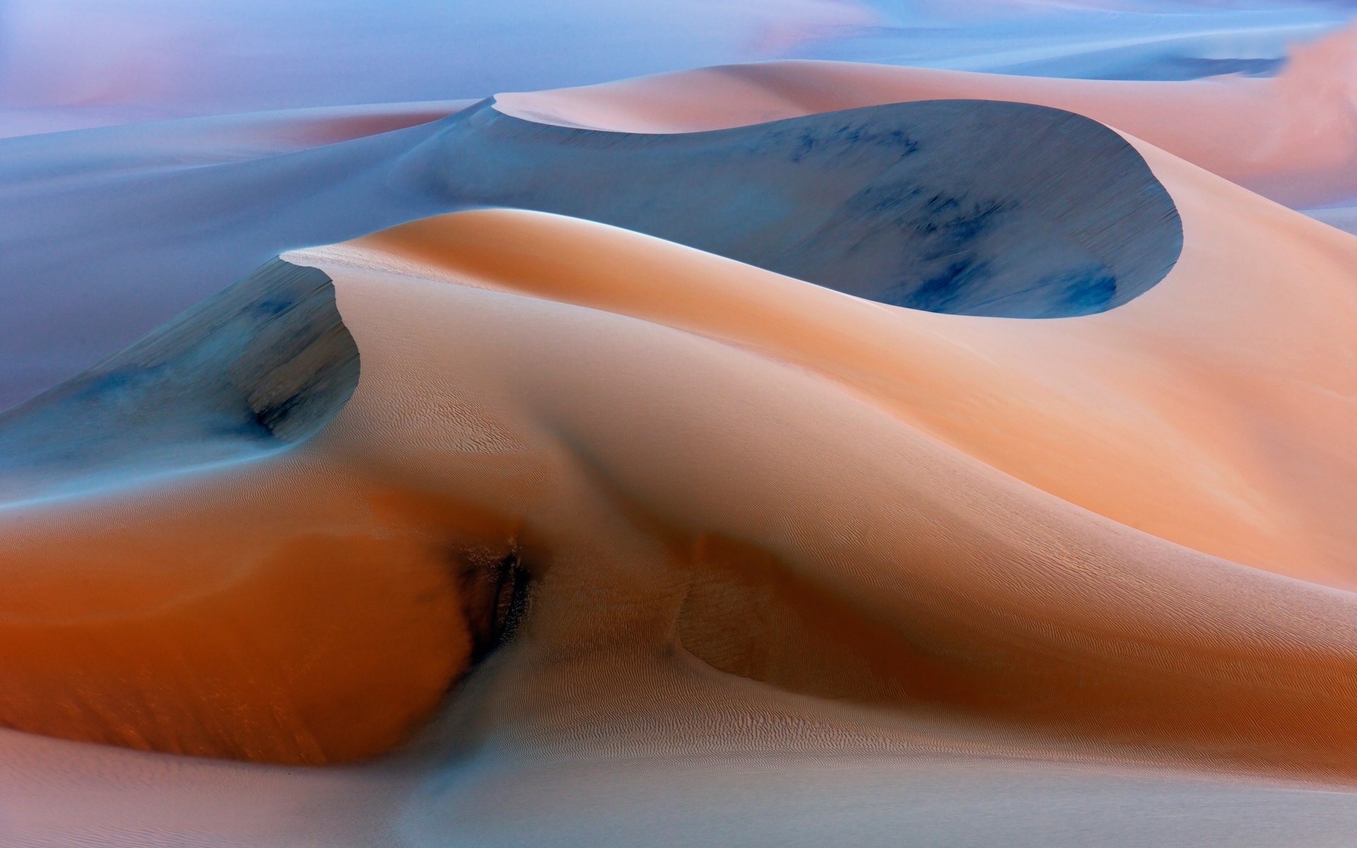 Abstract desert sand dunes with blue and orange hues HD Wallpaper