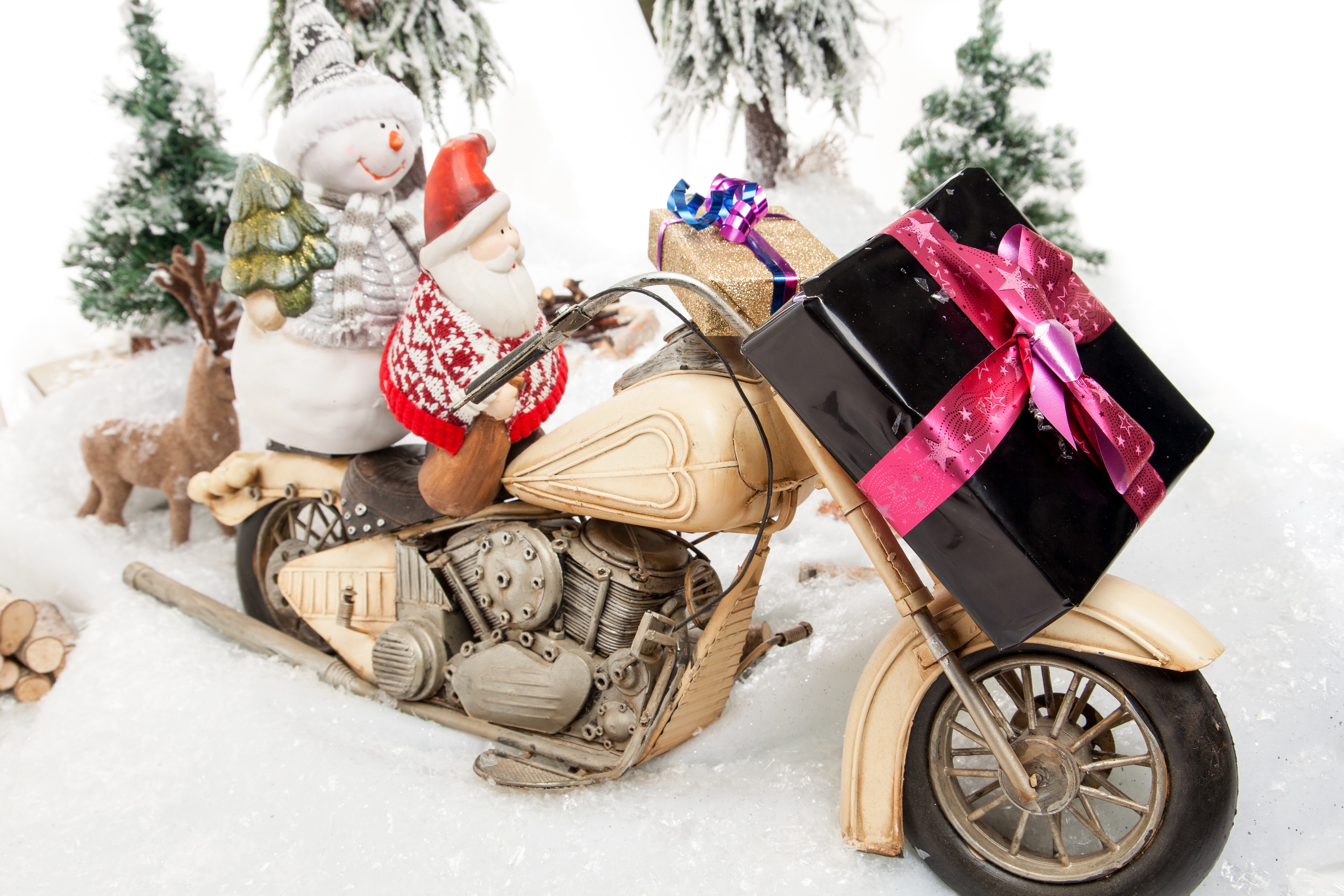 Christmas scene with Santa, snowman, reindeer, and gifts on a motorcycle HD Wallpaper