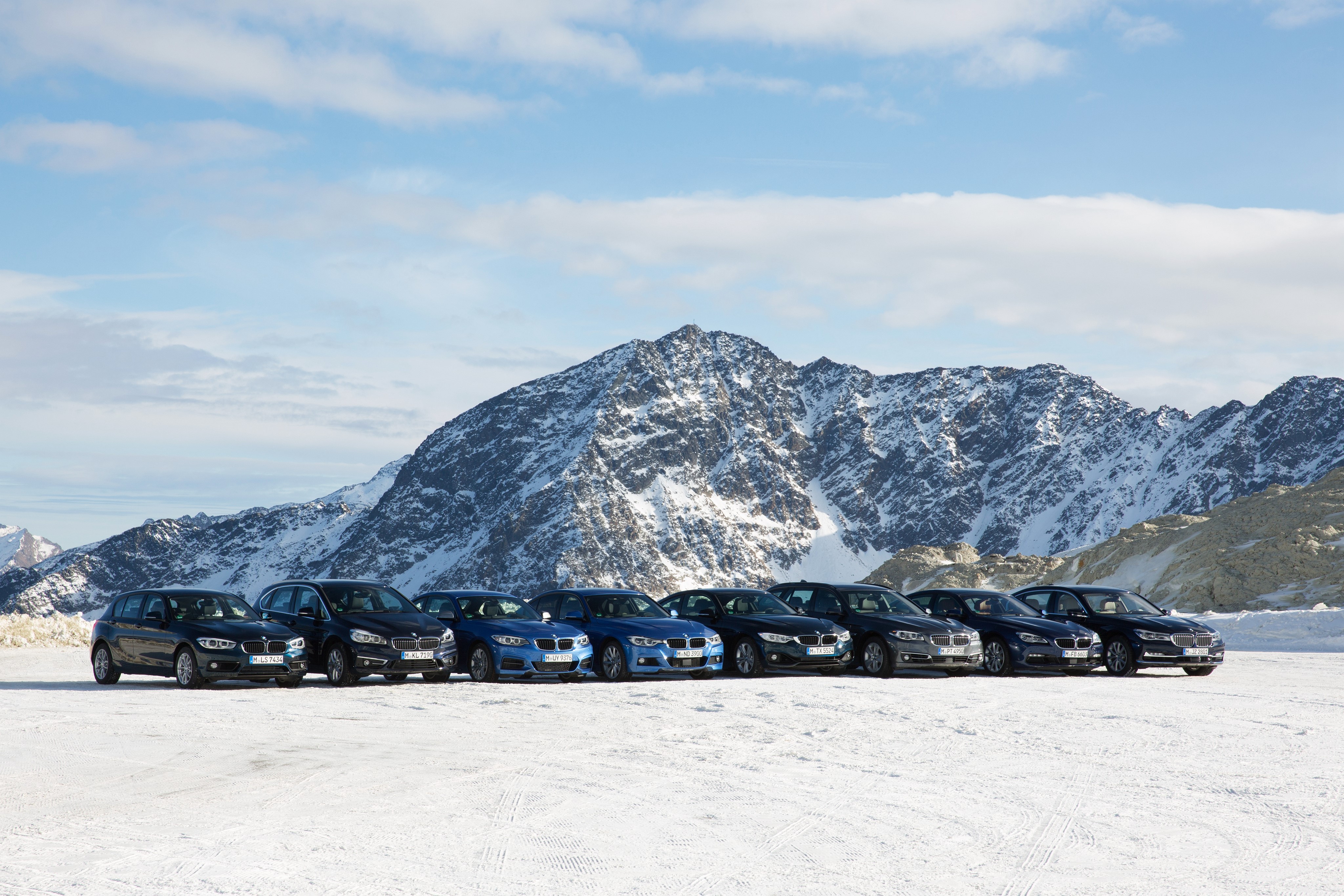 BMW Cars Lined Up in Snowy Mountains HD Wallpaper