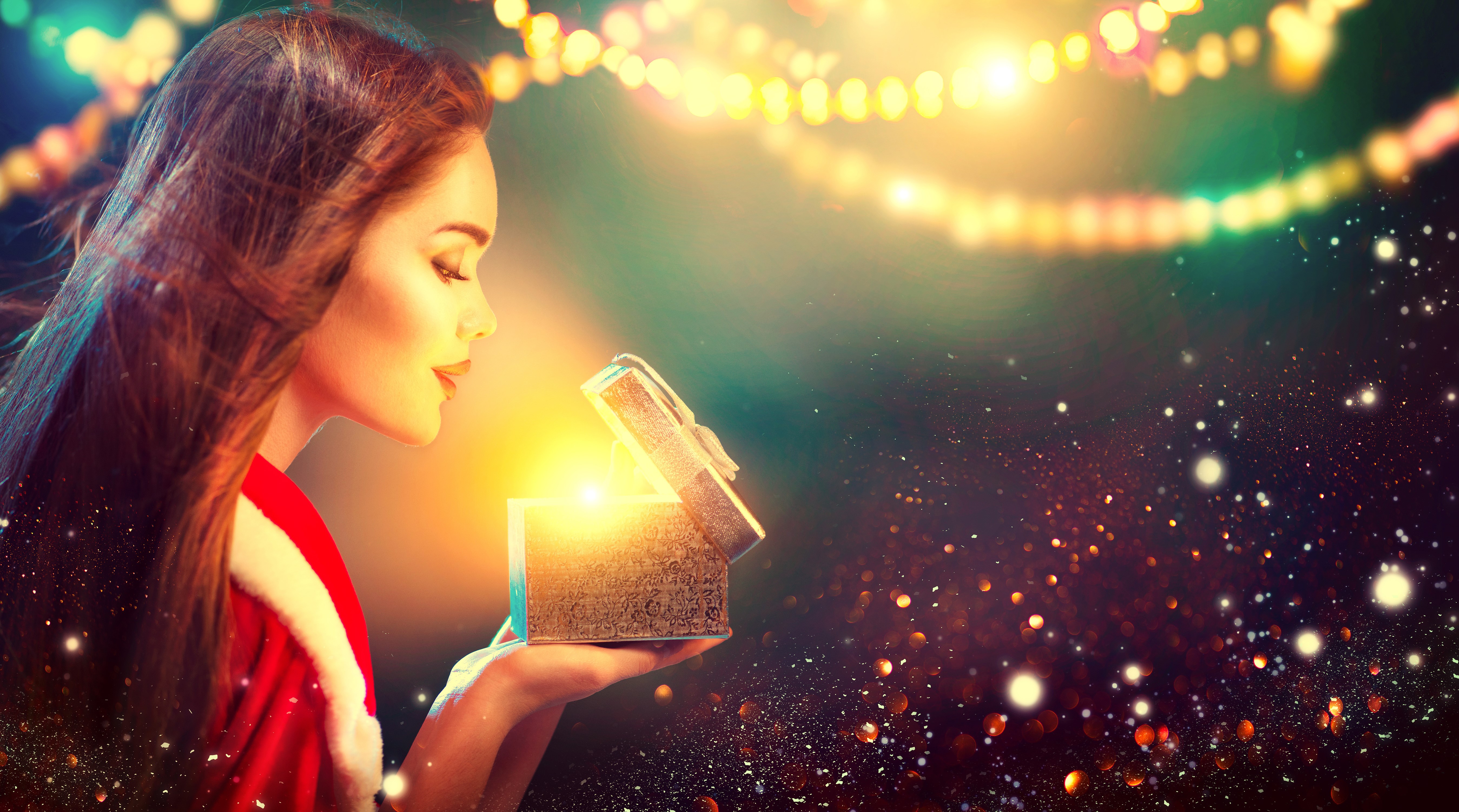 Woman opening a glowing Christmas gift HD Wallpaper