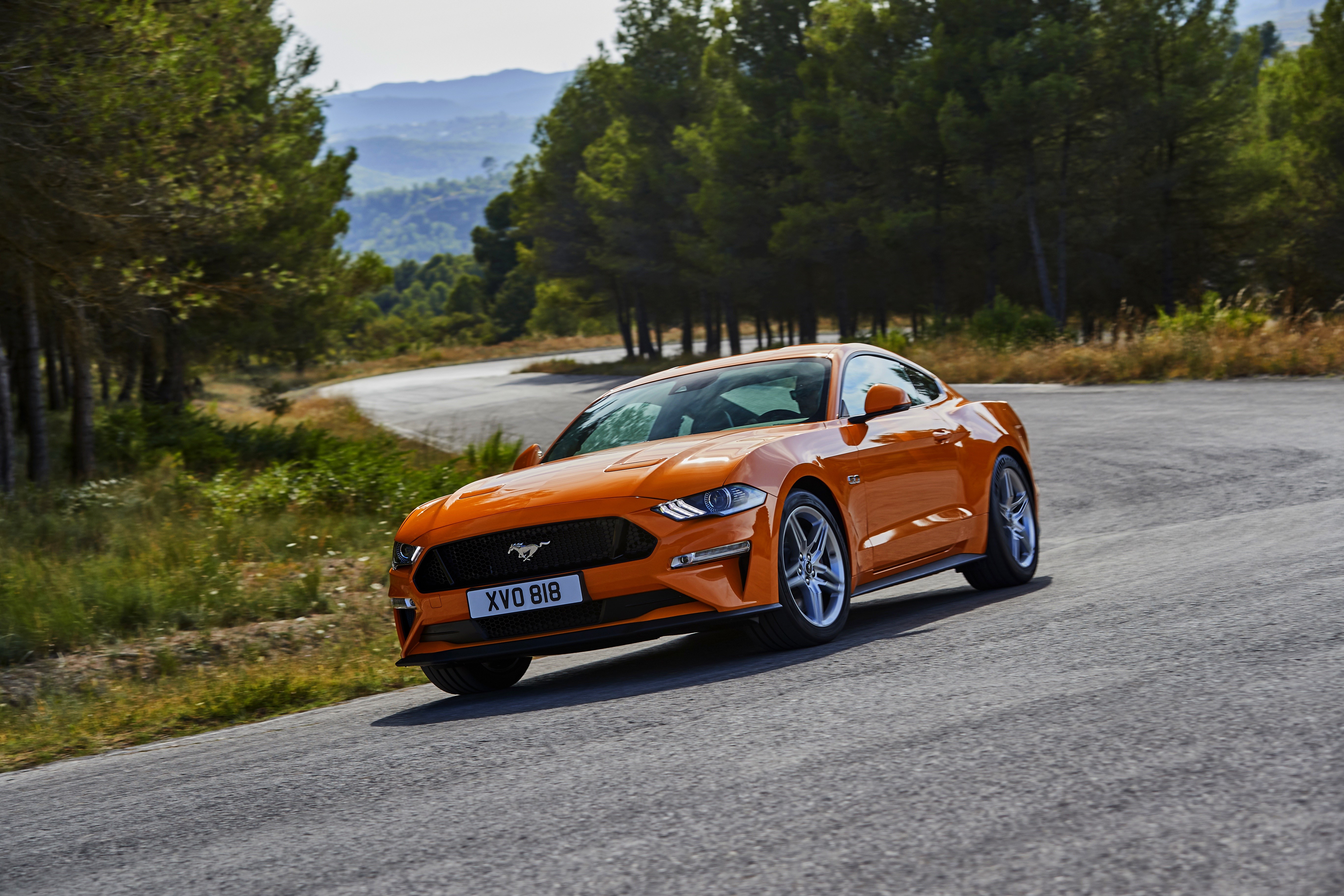 Orange 2018 Ford Mustang GT on a winding road HD Wallpaper
