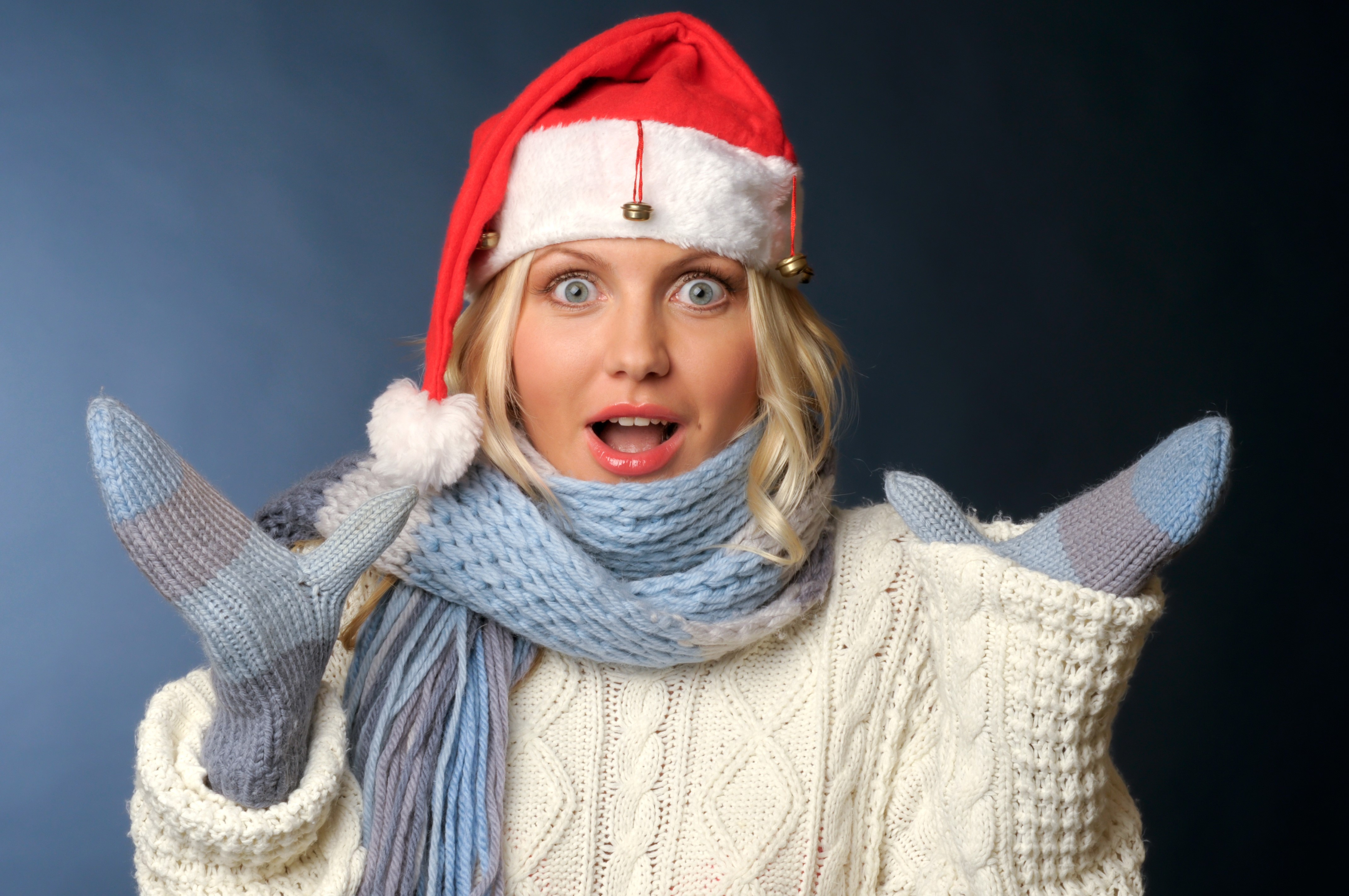 Woman in Santa hat and winter clothes with surprise emotion HD Wallpaper
