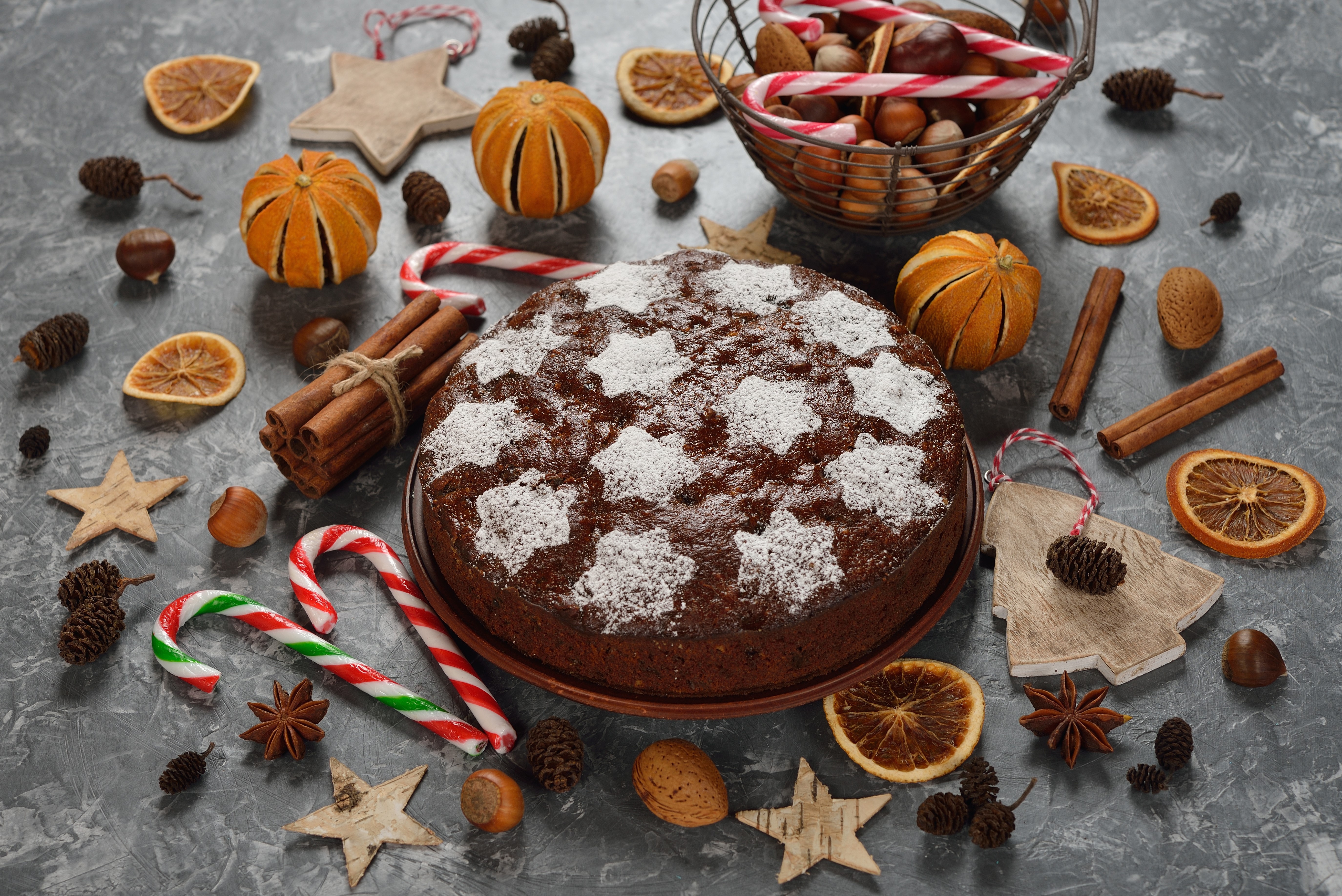 Christmas cake with star anise, cinnamon, nuts, and dried oranges HD Wallpaper