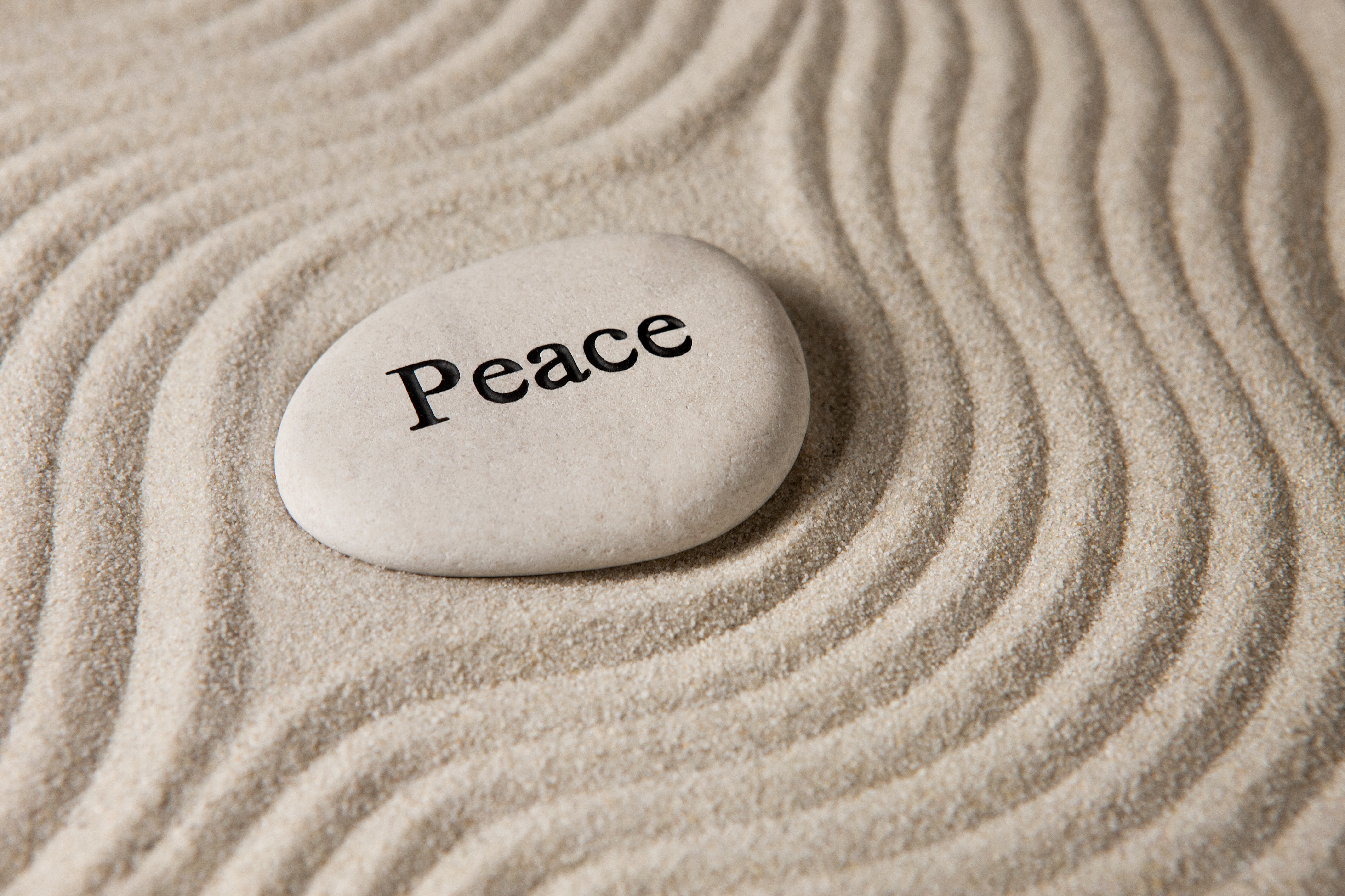 Zen peace stone on raked sand HD Wallpaper