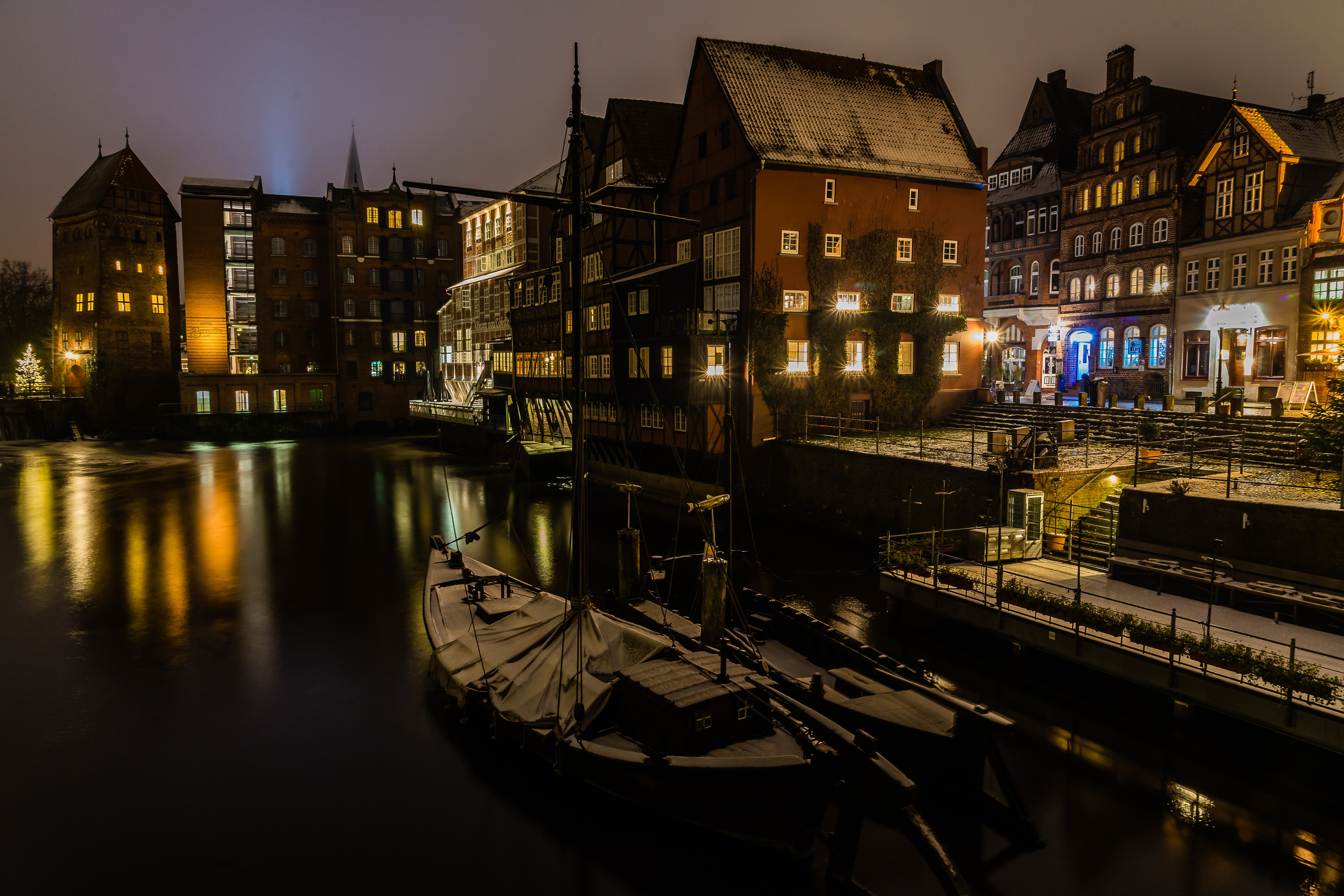 Night view of Lüneburg, Germany with river and boats HD Wallpaper