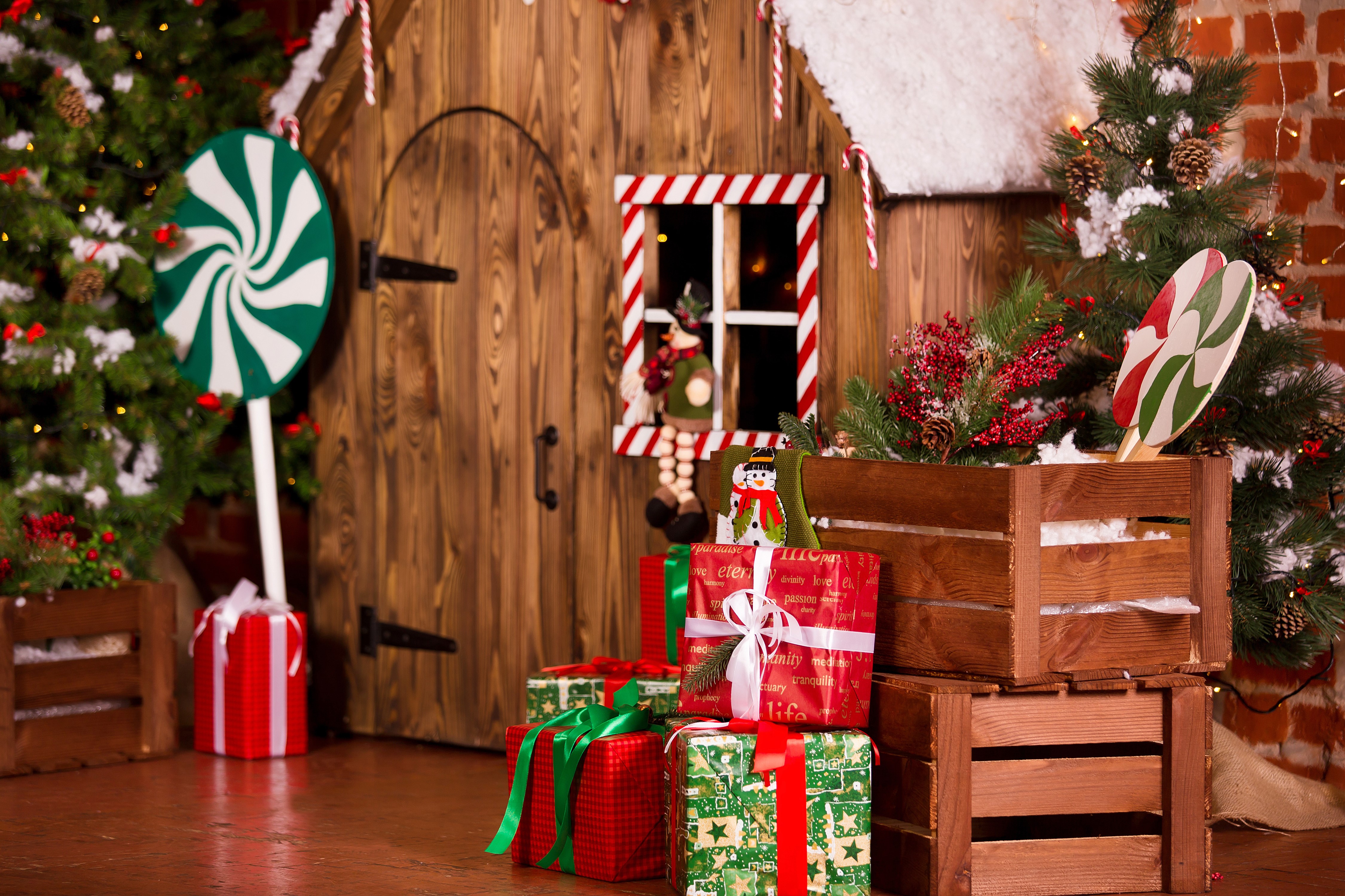 Christmas scene with decorated house and gifts HD Wallpaper