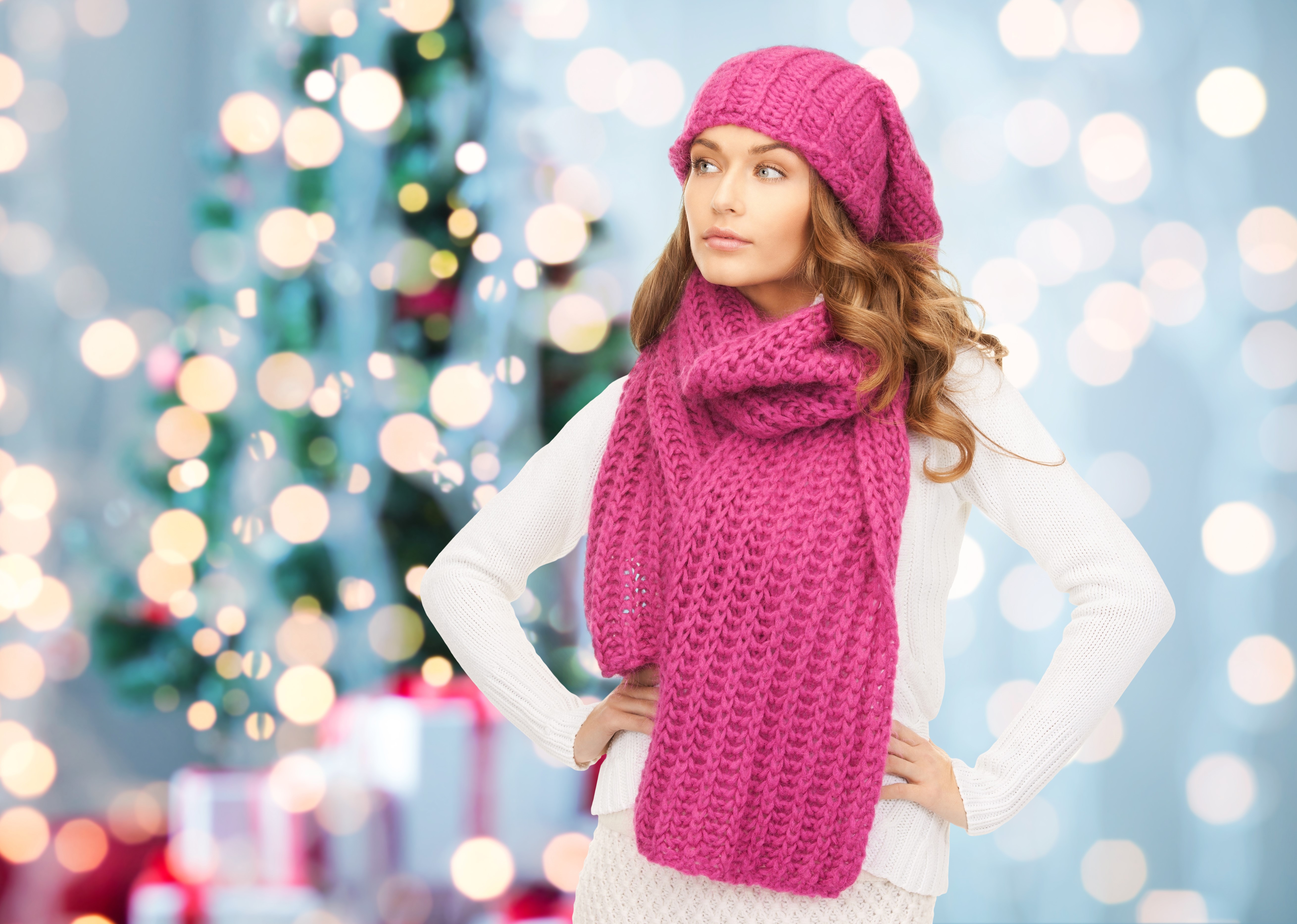 Woman in pink winter hat and scarf with Christmas tree HD Wallpaper