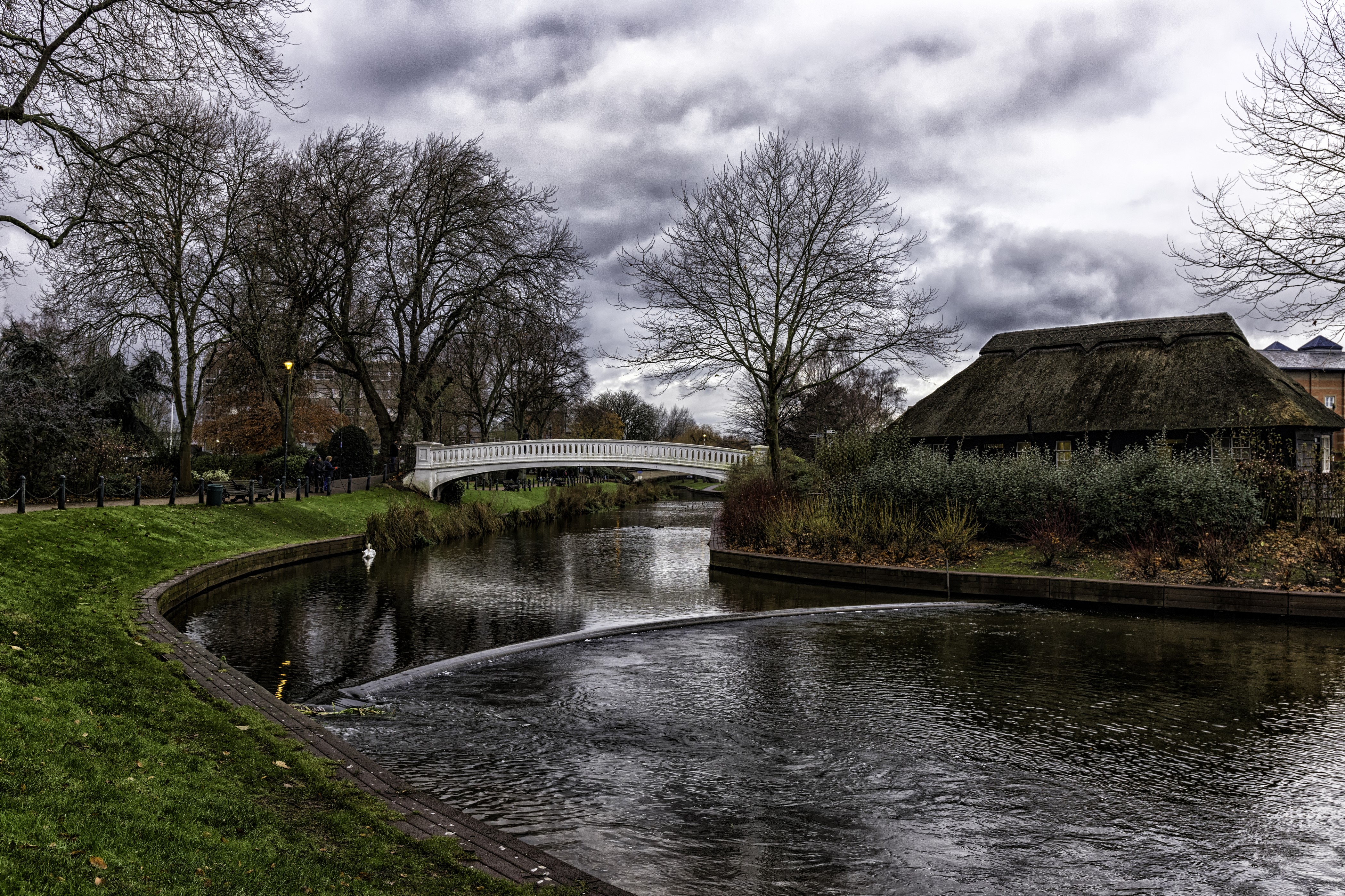 River with bridge and thatched house HD Wallpaper