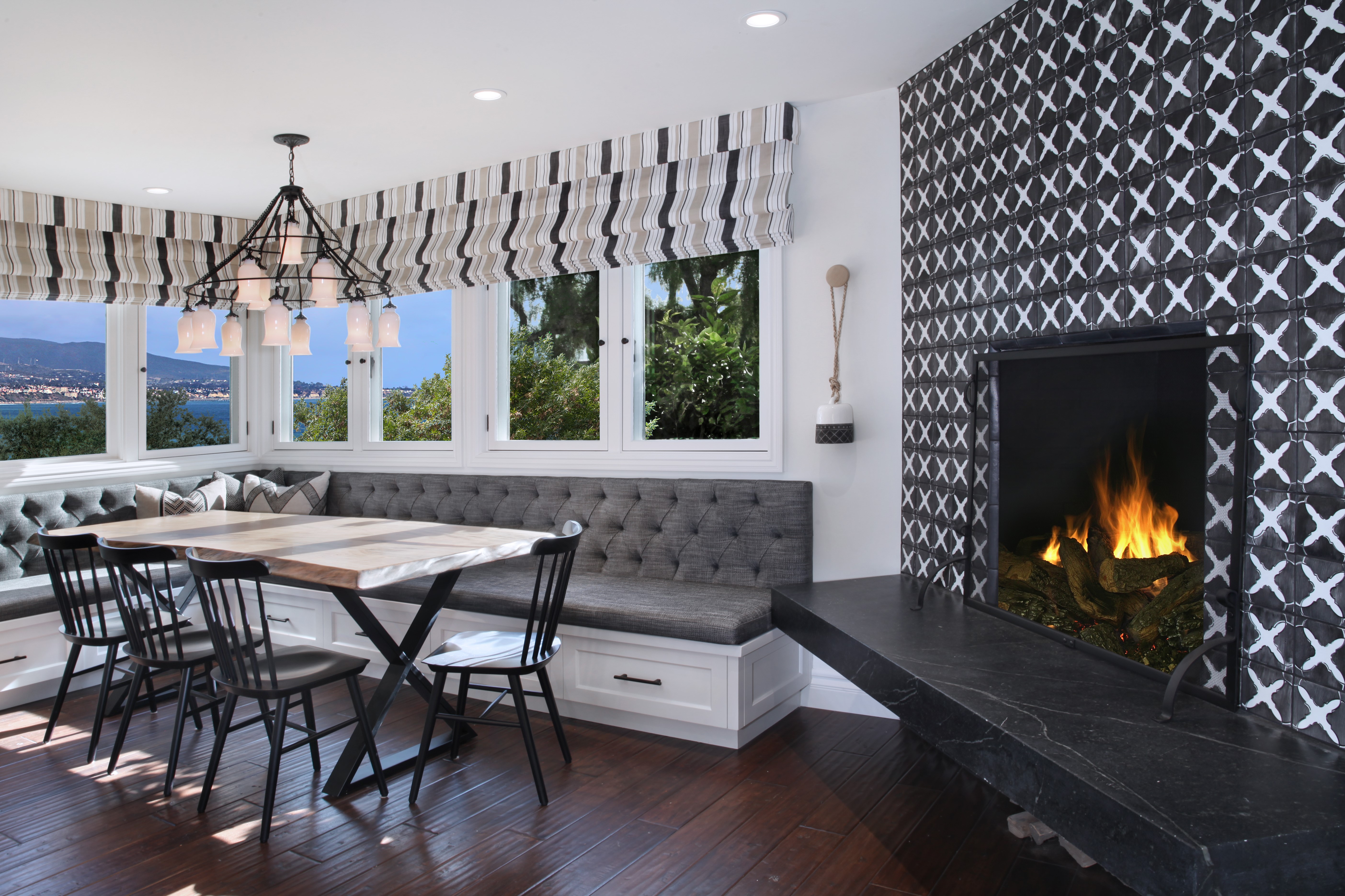 Dining area with banquette seating and fireplace HD Wallpaper