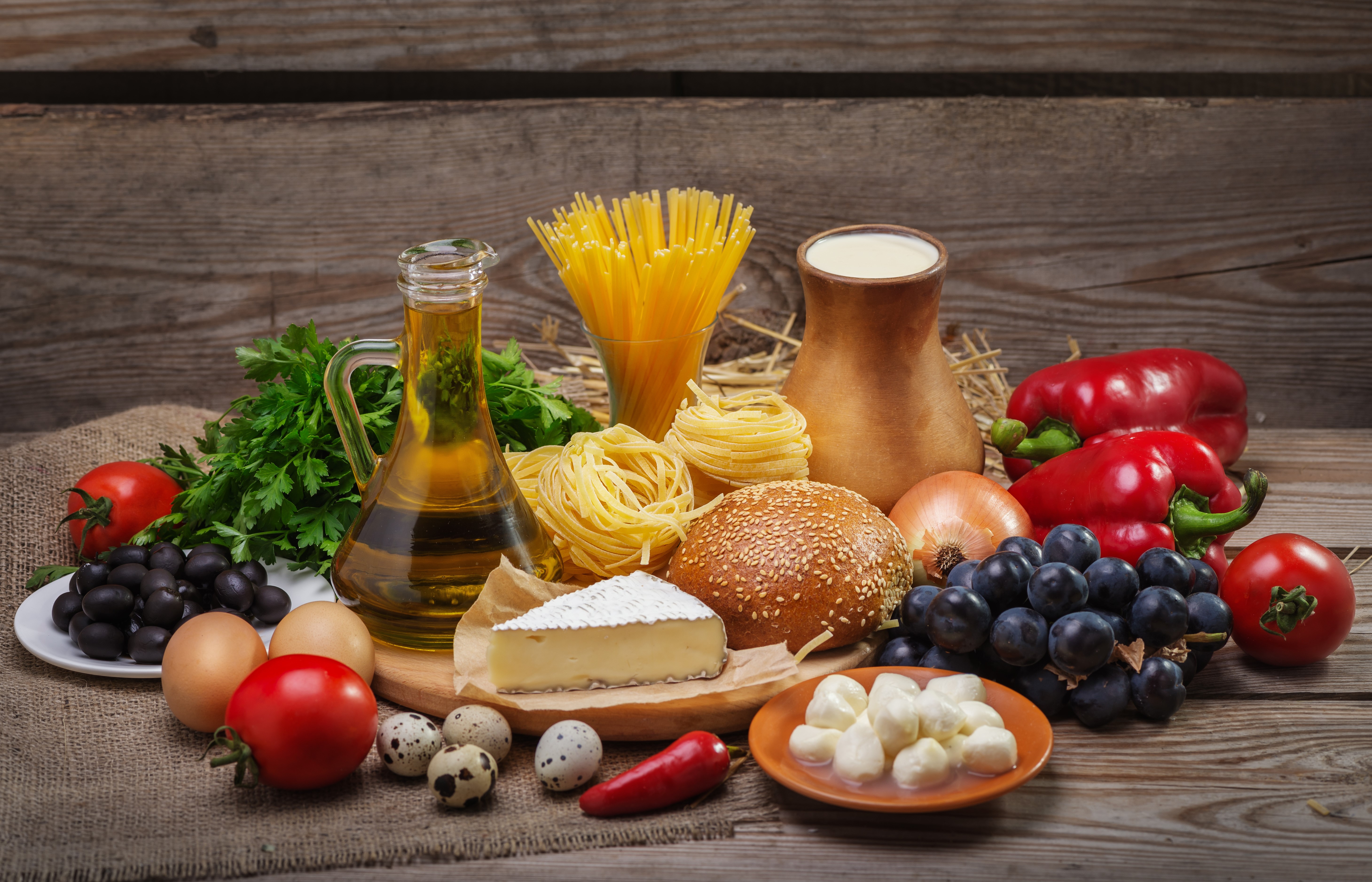 Still-life of Italian ingredients with pasta, cheese, and vegetables HD Wallpaper