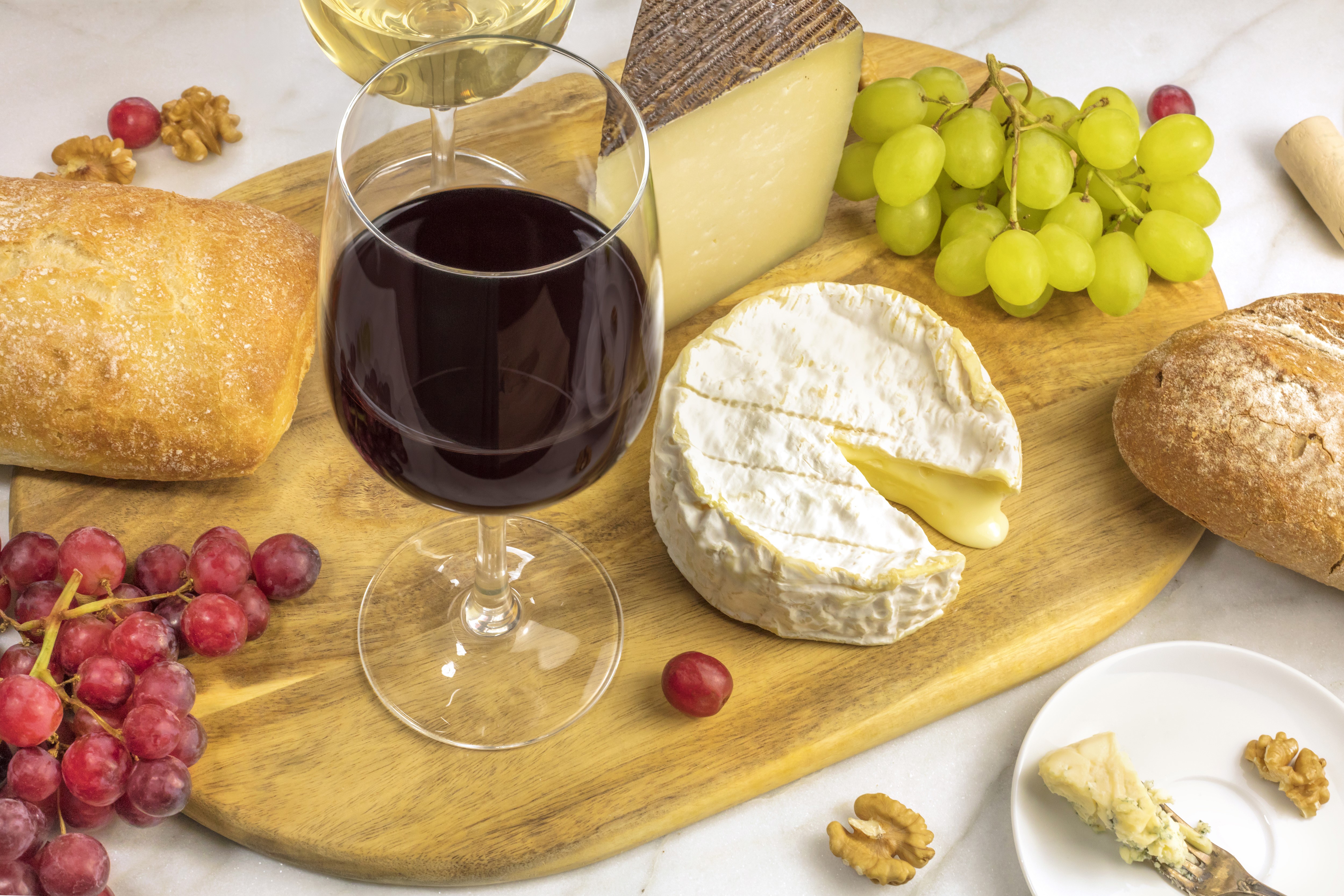 Wine, Grapes, Cheese, and Bread on a Cutting Board HD Wallpaper