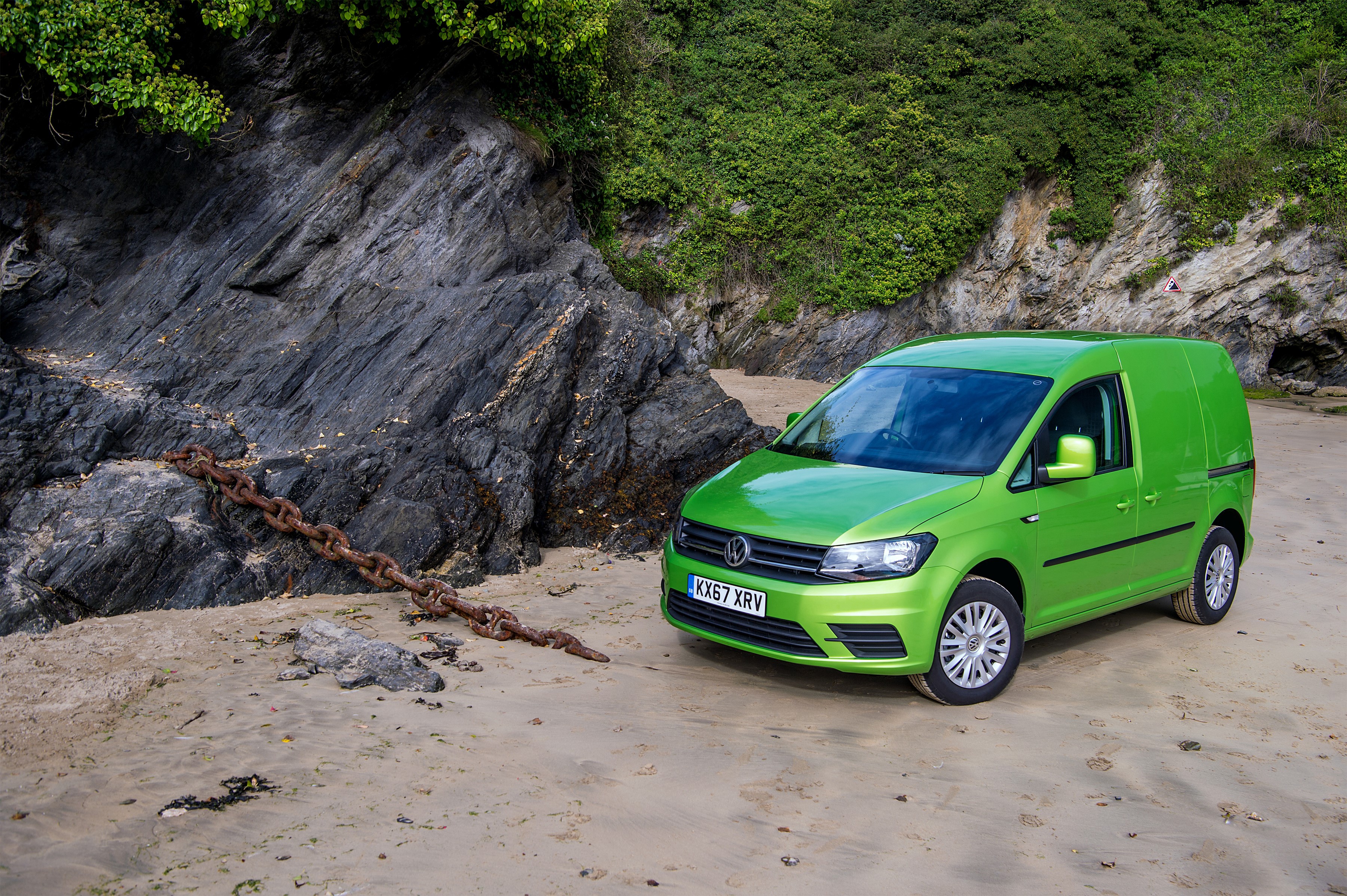 Green Volkswagen Caddy van on a beach with a chain HD Wallpaper