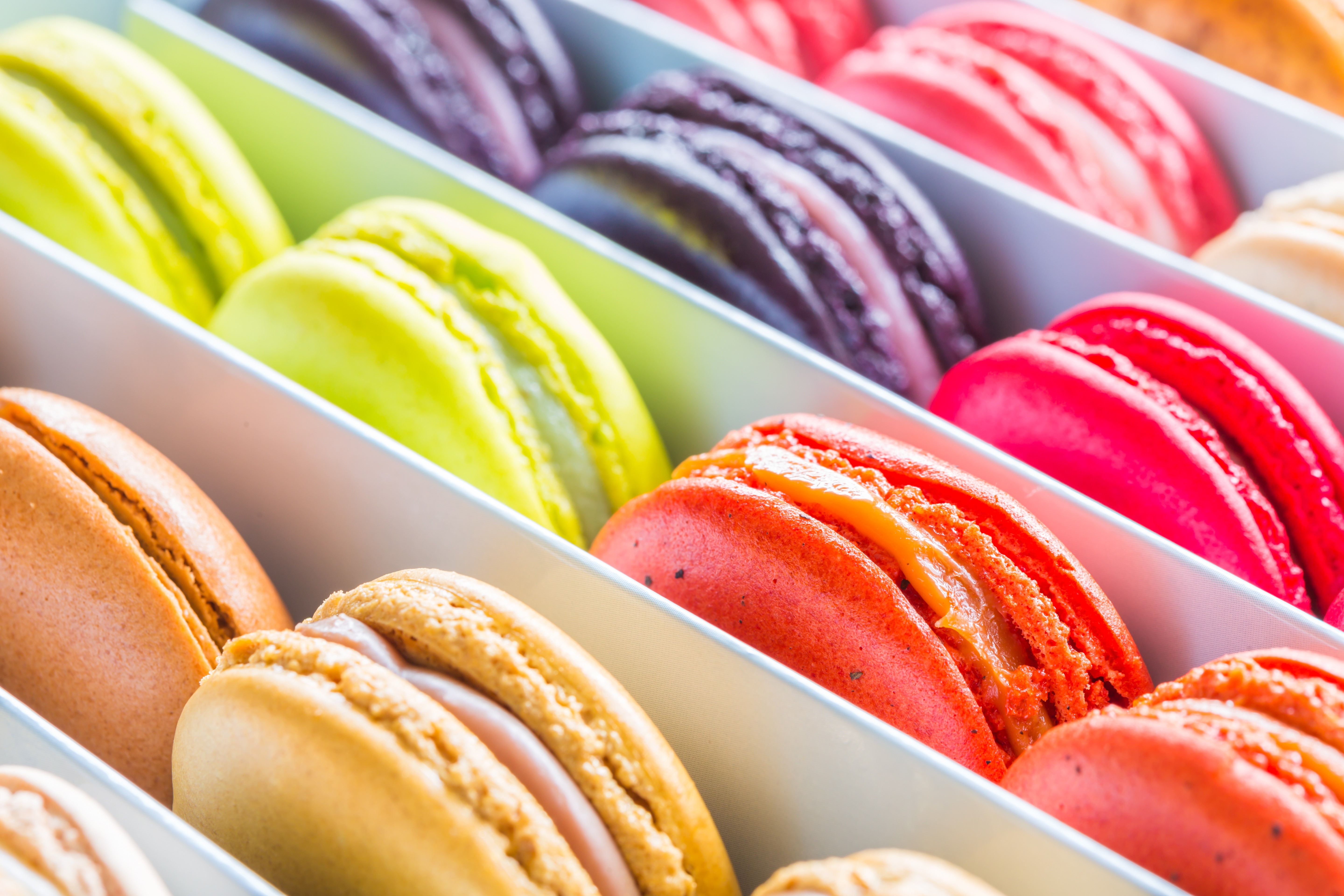 Assortment of colorful macarons in a box HD Wallpaper