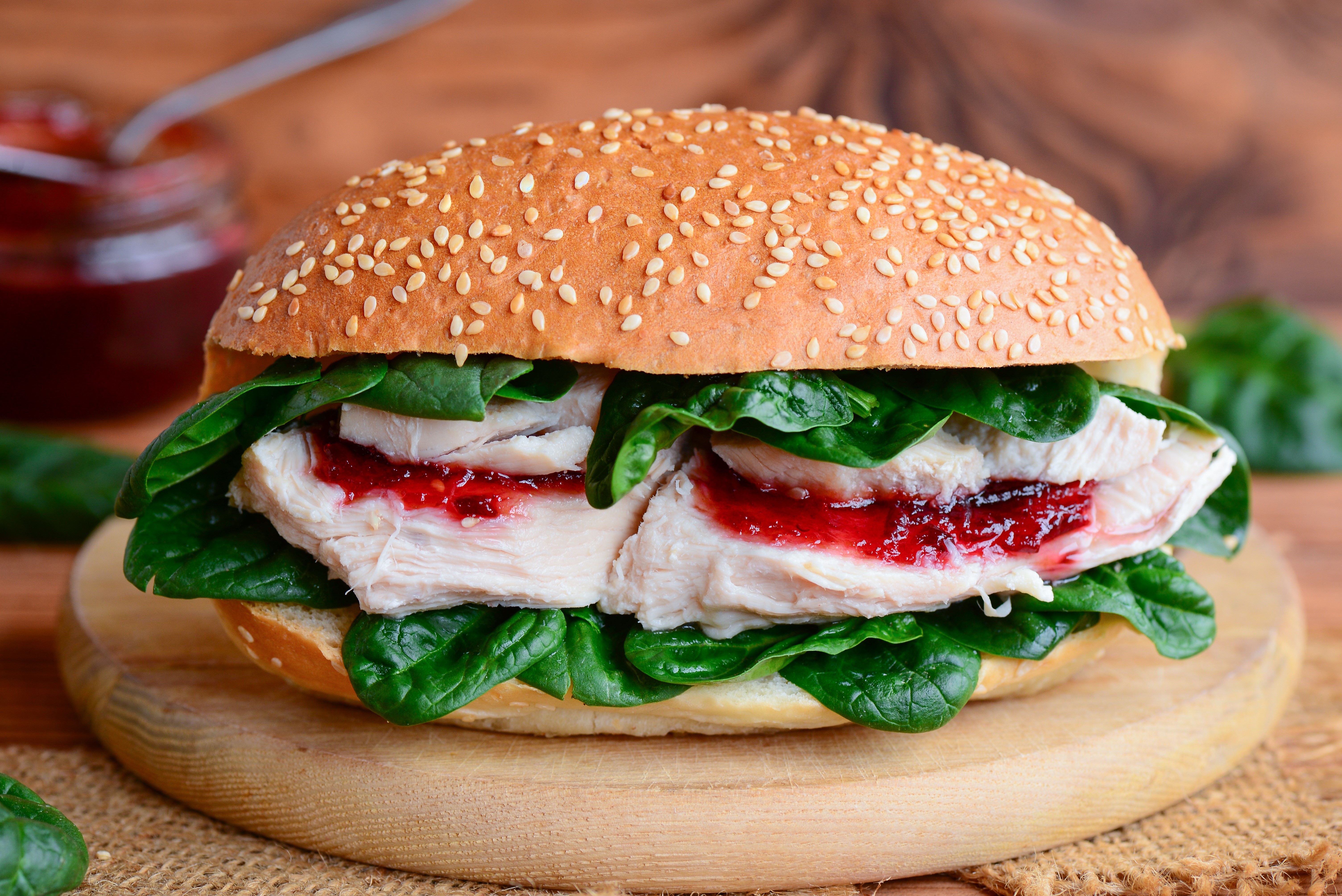 Sandwich with turkey, spinach, and cranberry sauce on a bun HD Wallpaper