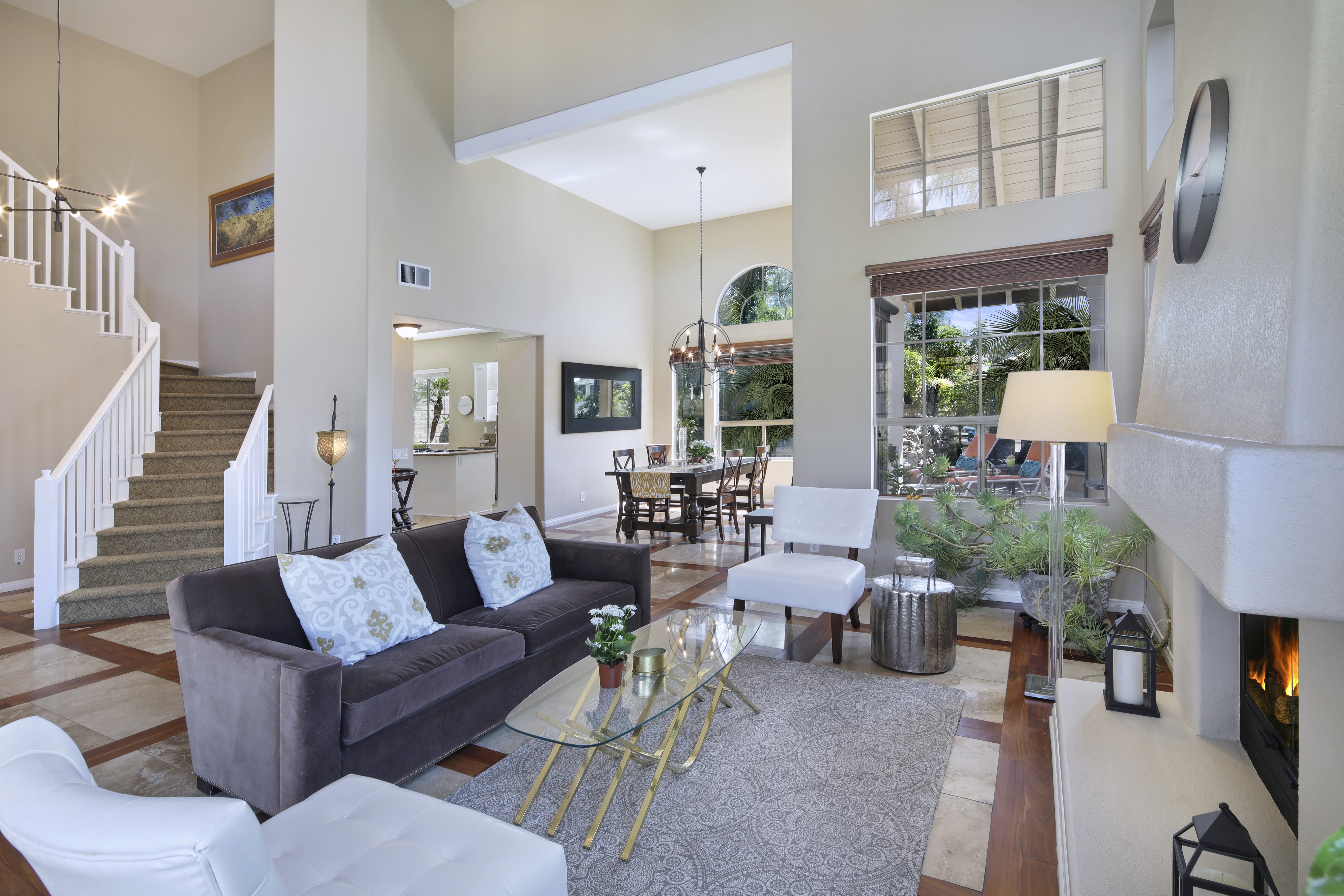 Living room with sofa, stairs, and dining area HD Wallpaper