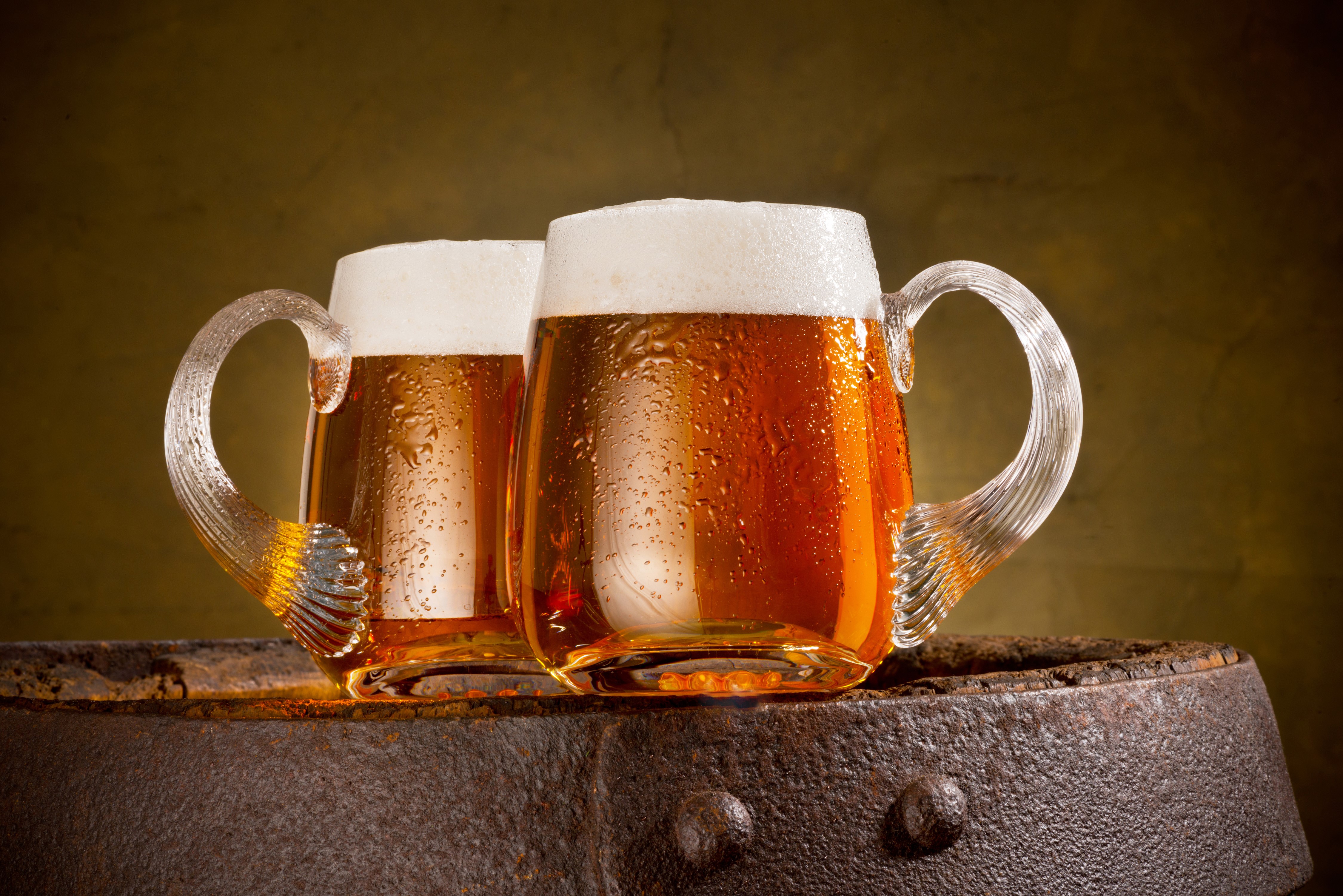 Two Mugs of Beer with Foam on a Barrel HD Wallpaper