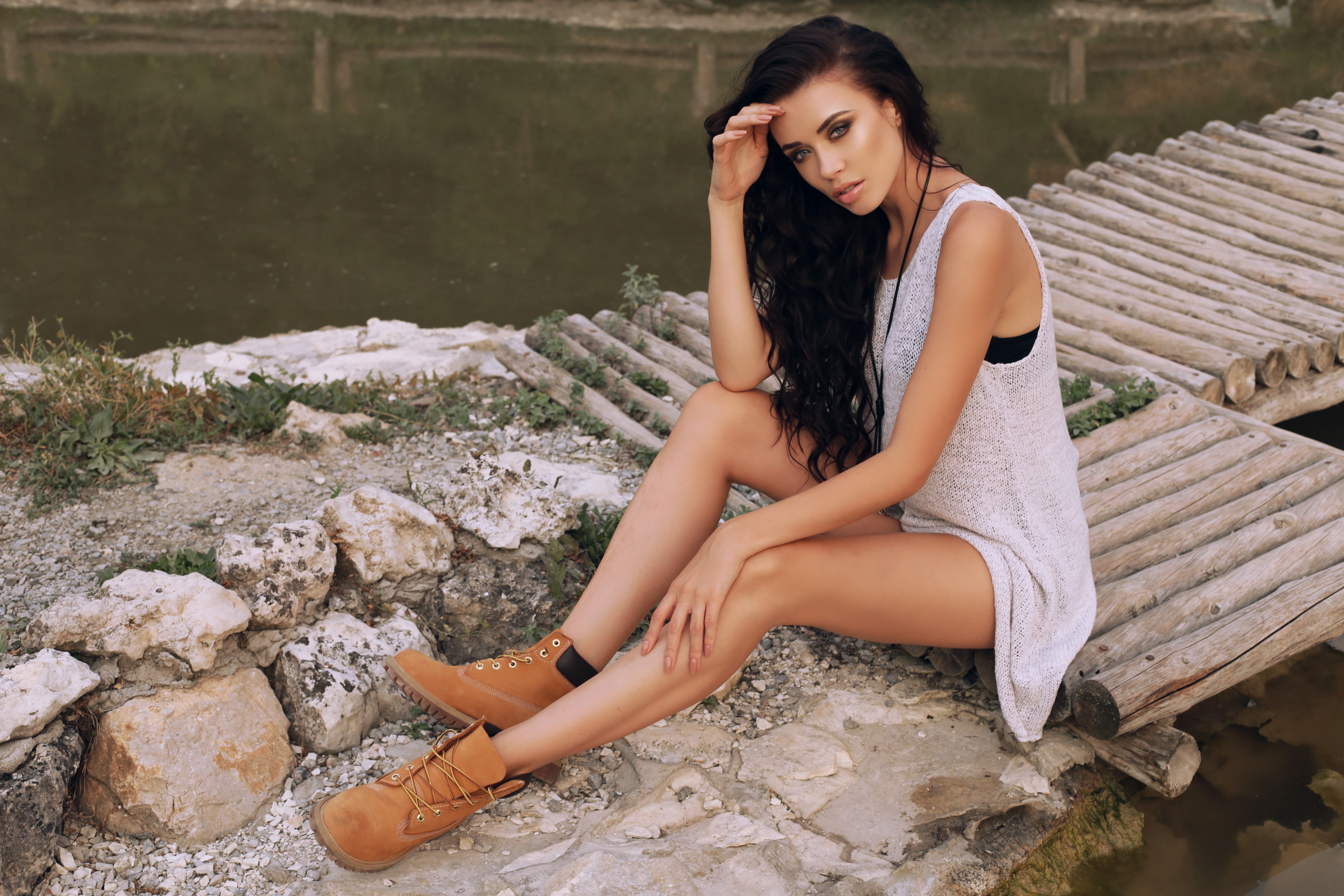 Brunette girl sitting on a wooden bridge HD Wallpaper