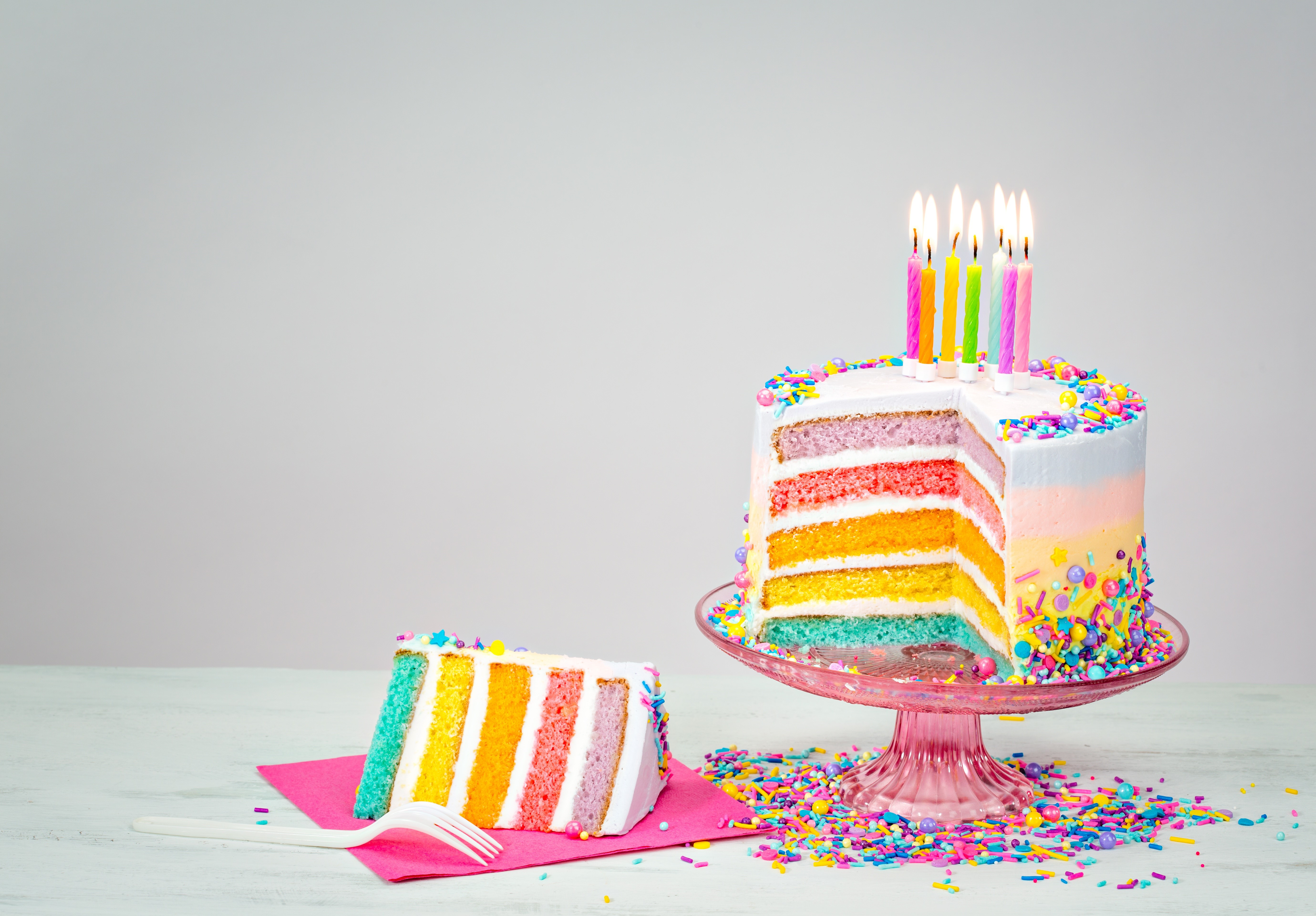 Rainbow Layer Cake with Candles and a Slice HD Wallpaper