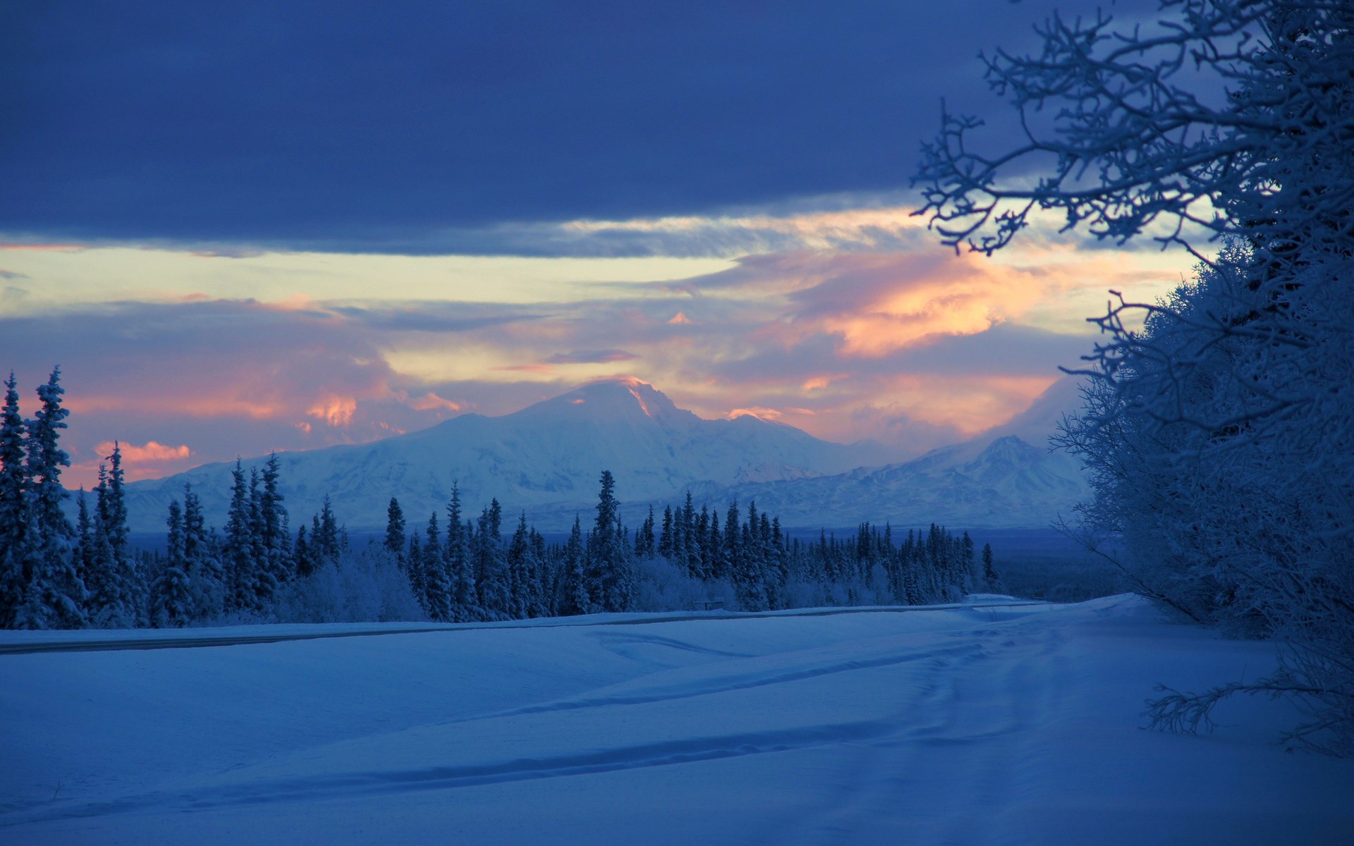 Snowy landscape with mountains and colorful sunset sky HD Wallpaper