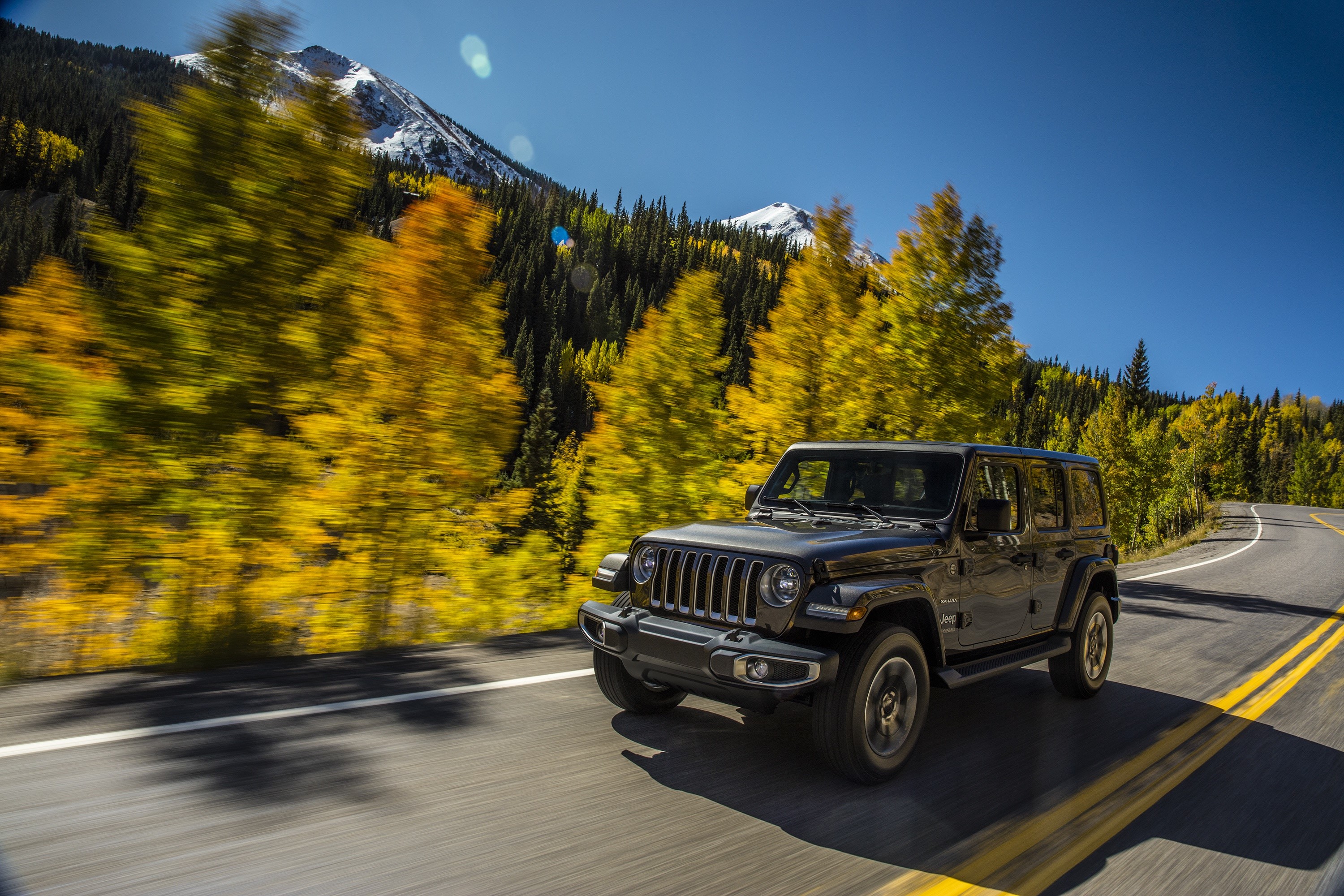 Black Jeep Wrangler driving on a mountain road in autumn HD Wallpaper