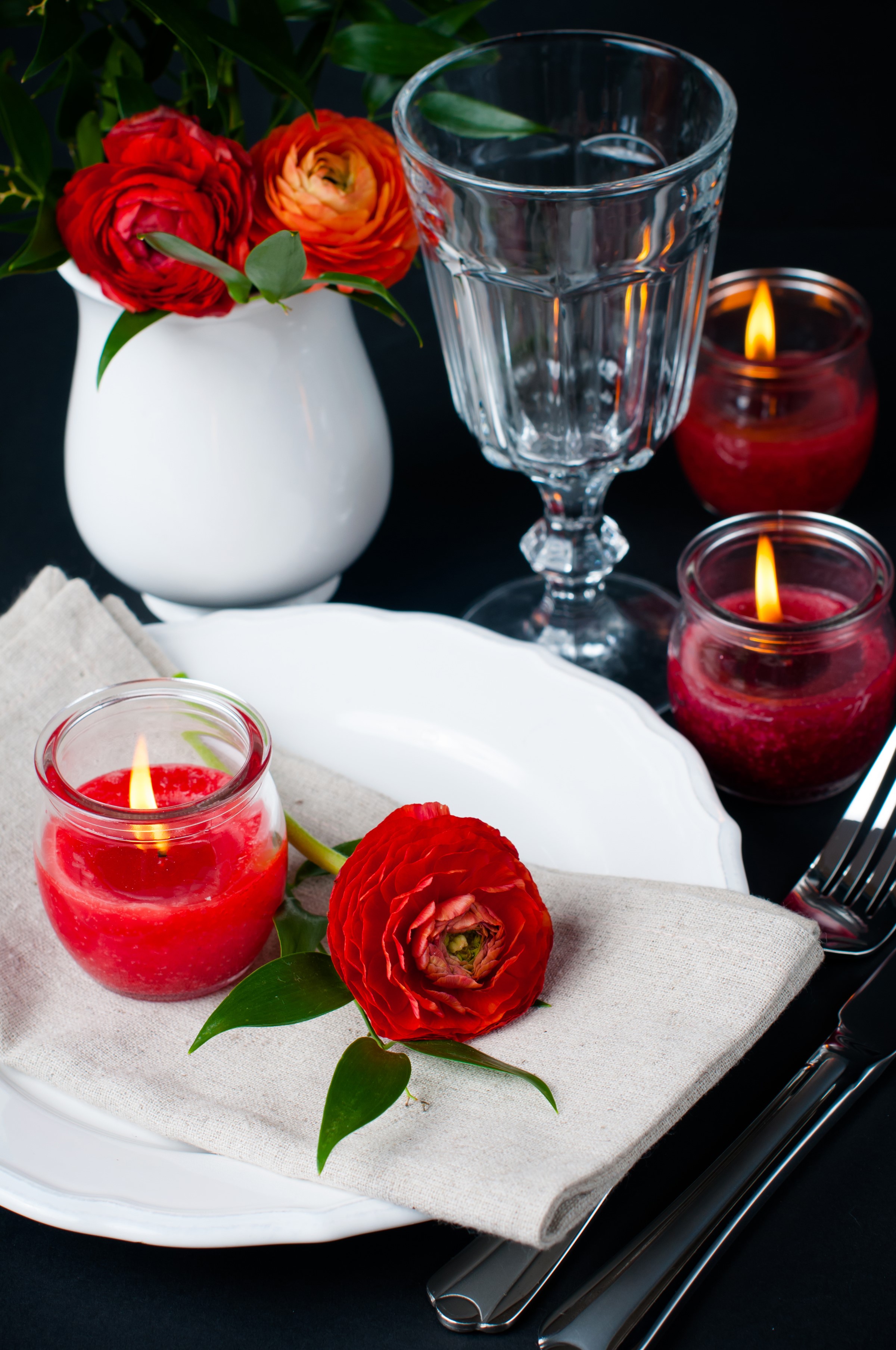 Table setting with red ranunculus flowers and candles HD Phone Wallpaper