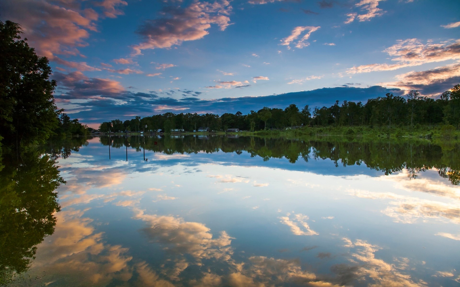 Sunset clouds reflected in a calm lake with trees HD Wallpaper